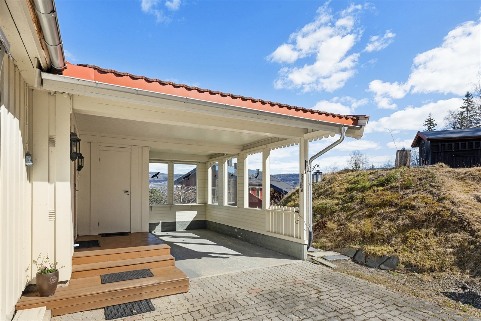 Carporten på 16 m2 og bod på 4 m2 er bygget inntil inngangspartiet. Galleribilde