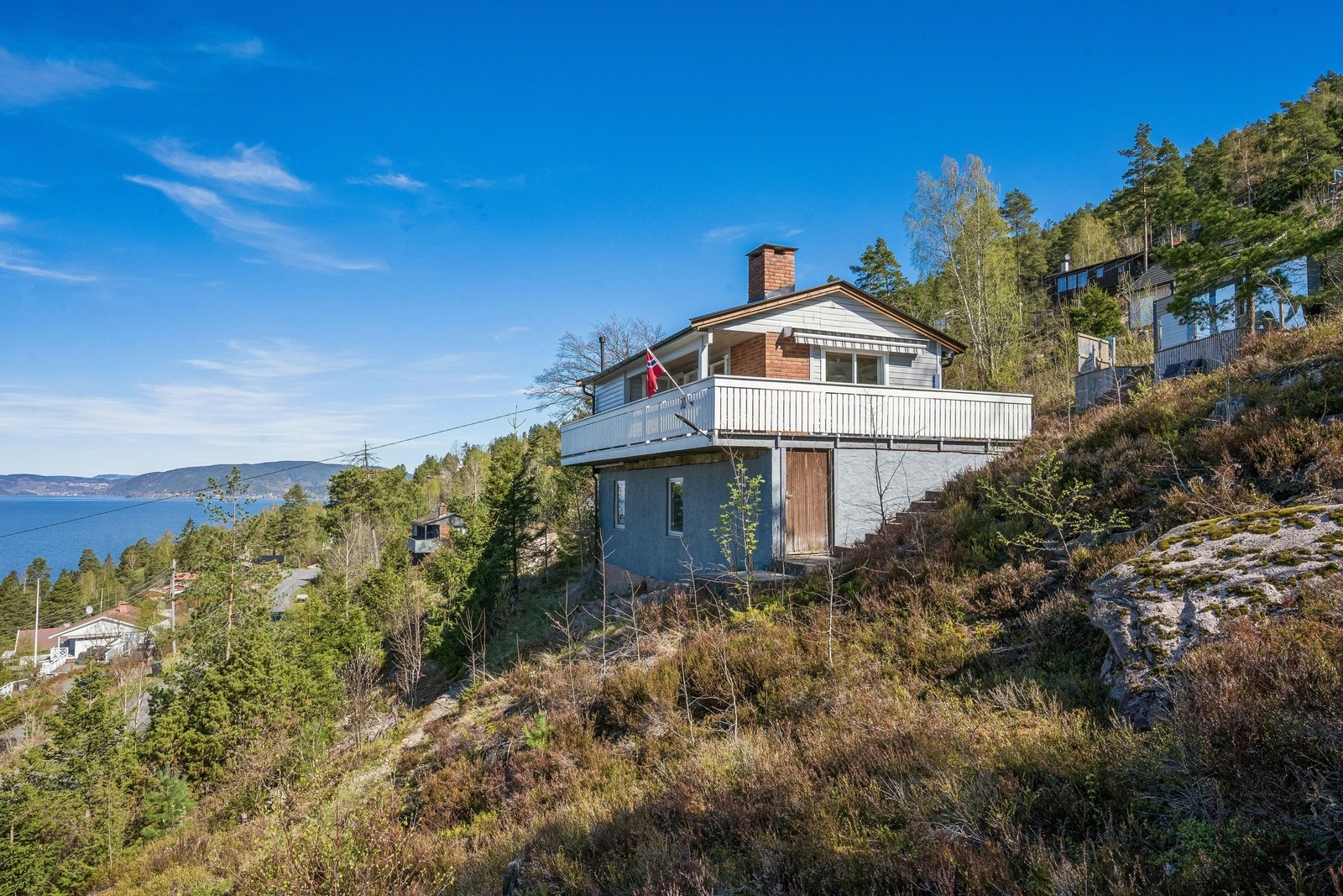 Hytta ligger i skrånende naturtomt. Det er etablert vei fra parkeringsplass nedenfor hytta Galleribilde
