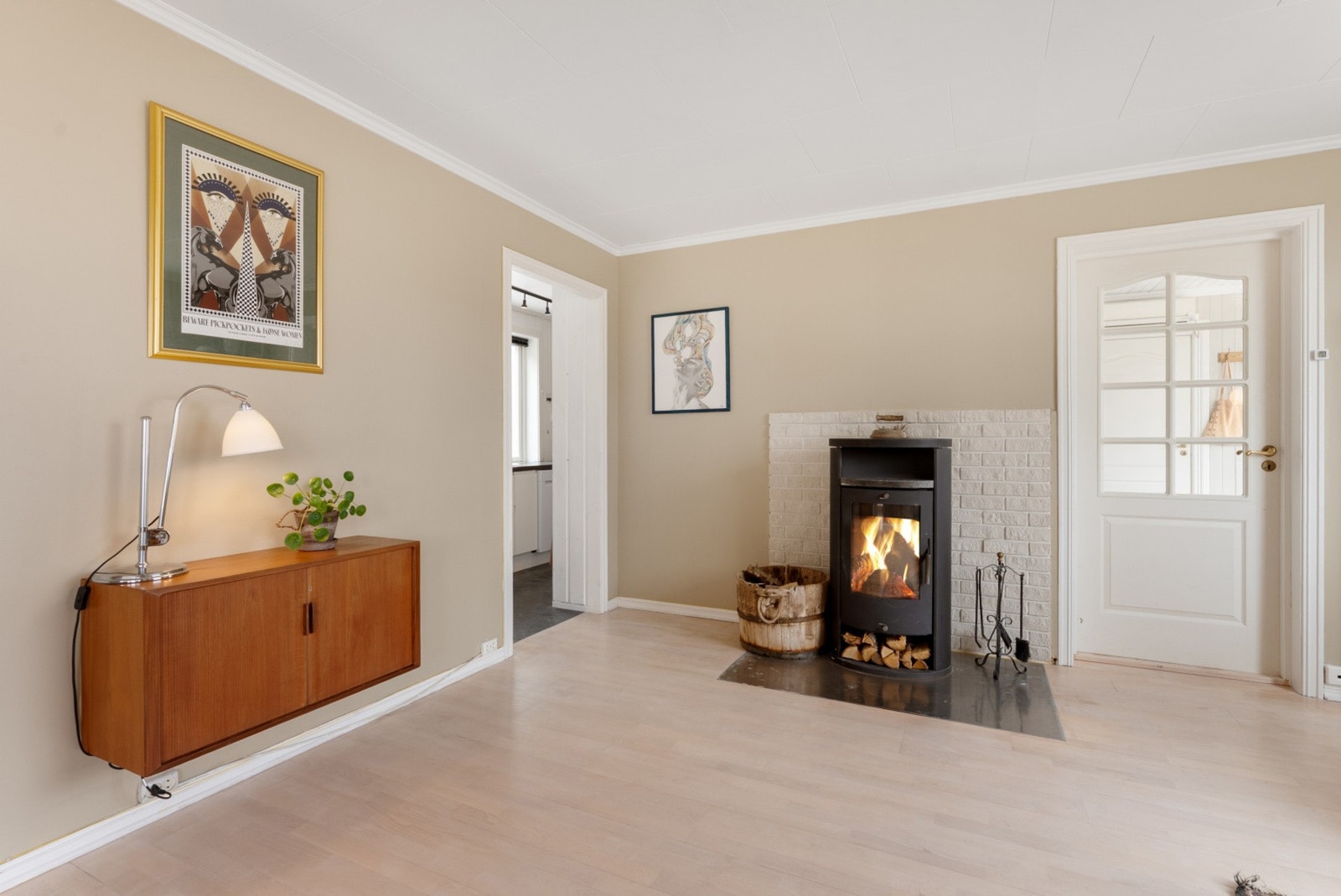 En klassisk vedovn er sentralt plassert i rommet, og bidrar ikke bare med effektiv varme, men også med en ekstra dose hygge på kjølige kvelder. Galleribilde