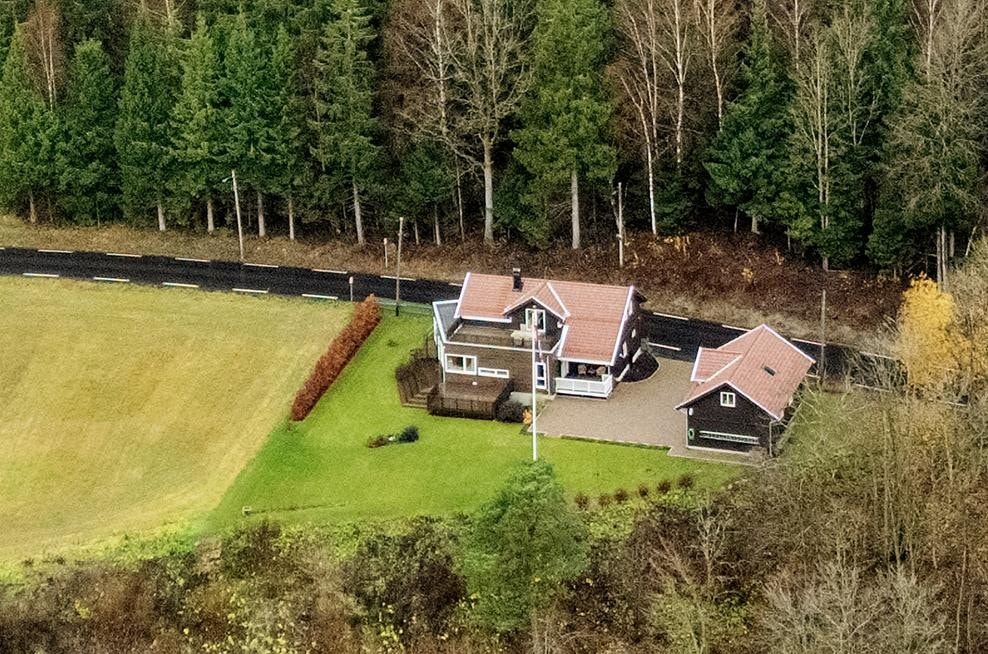 Landlig og fritt med lettstelt flat hage og steinsatt gårdsplass Galleribilde