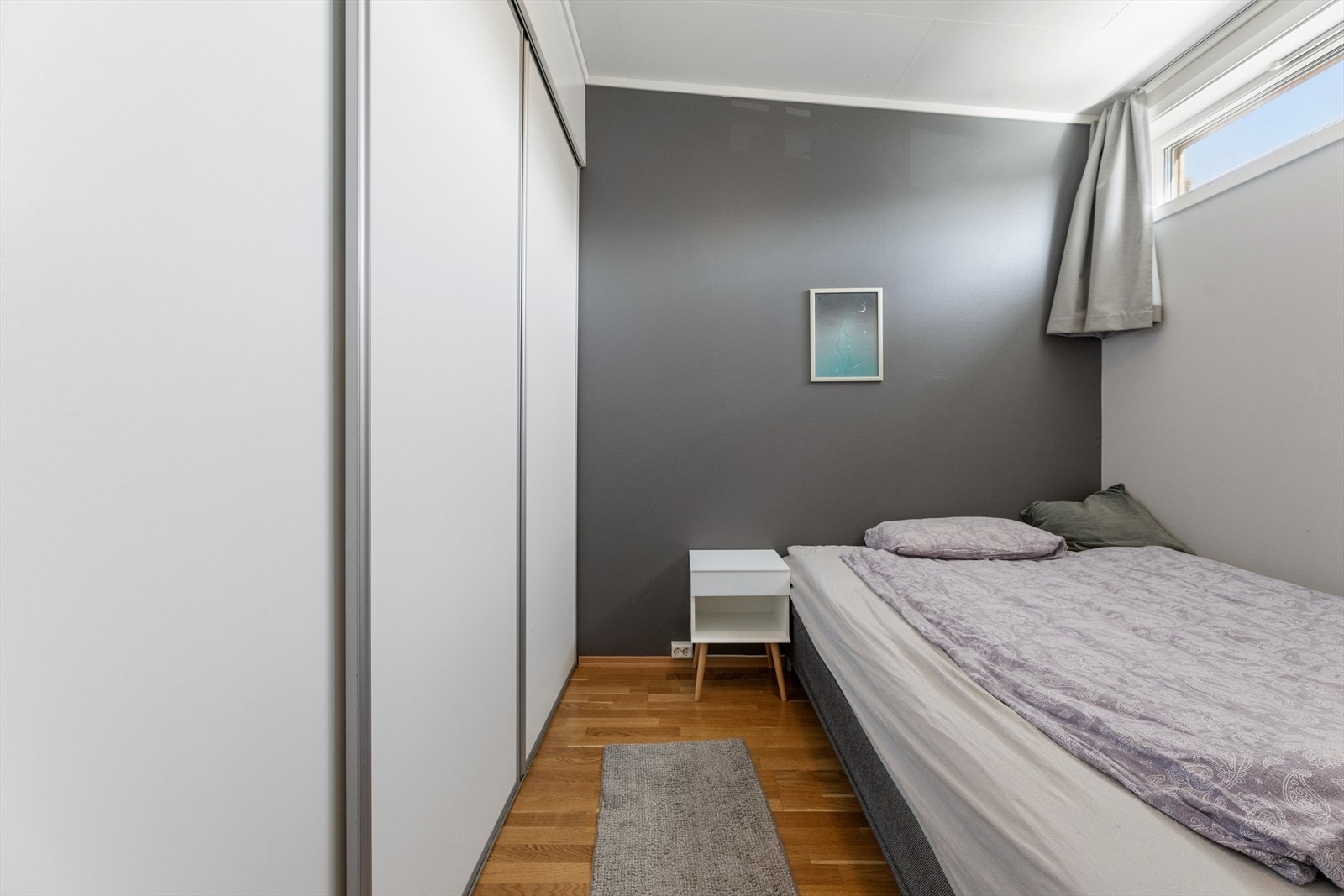 På soverommet er det etablert en praktisk skyvedørsgarderobe som gir gode oppbevaringsmuligheter. Galleribilde
