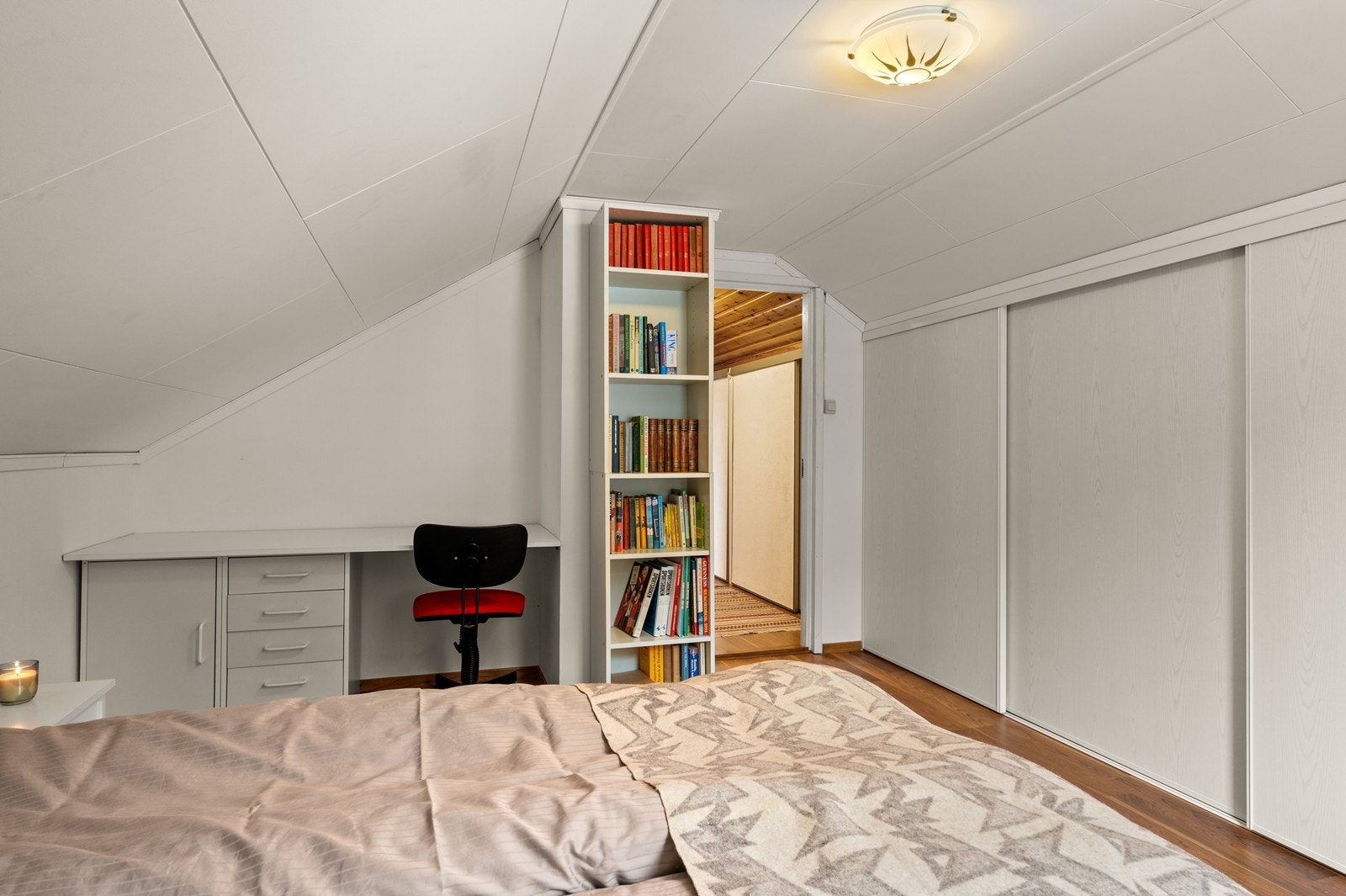 Smarte løsninger for oppbevaring ved hjelp av skyvedører i kneveggen, i tillegg er det plass til en liten arbeidsplass. Galleribilde