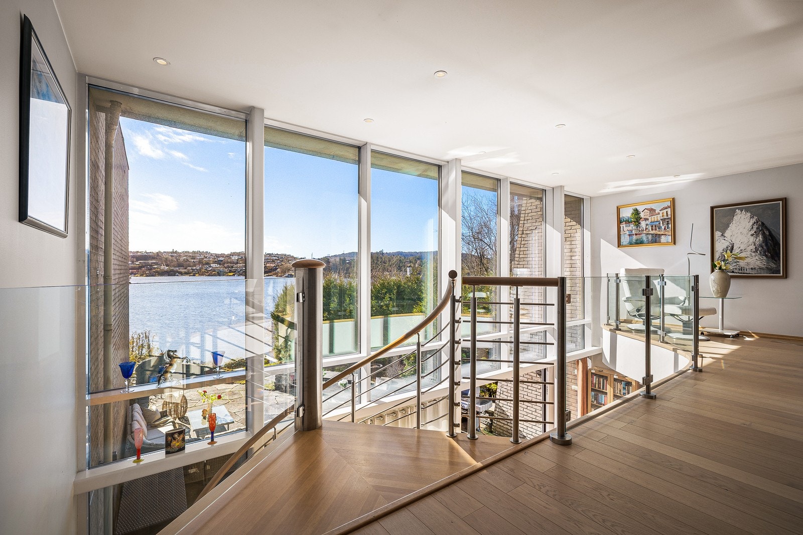 Store vindusflater i front av boligen rammer inn en utsikt du aldri blir lei av - et storslått panorama som gir hjemmet et unikt og varig preg. Galleribilde