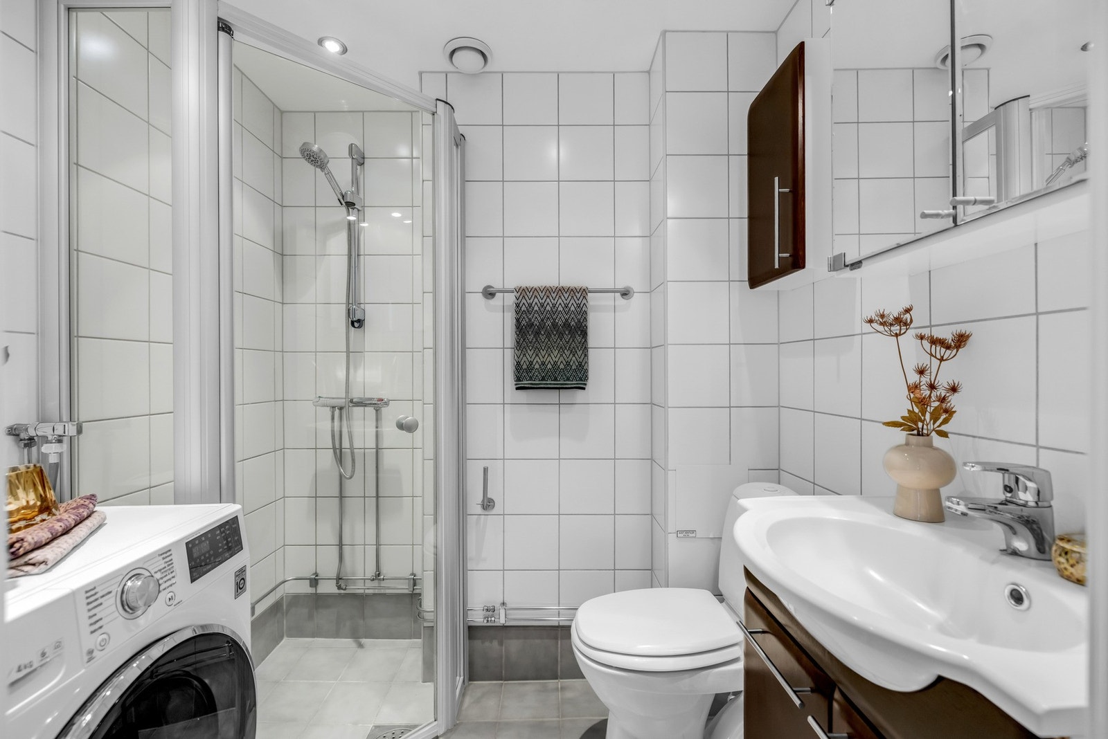 Stilrent flislagt baderom i en lys utførelse. Badet ble rehabilitert i regi av aksjelaget i 2002/2003 Galleribilde