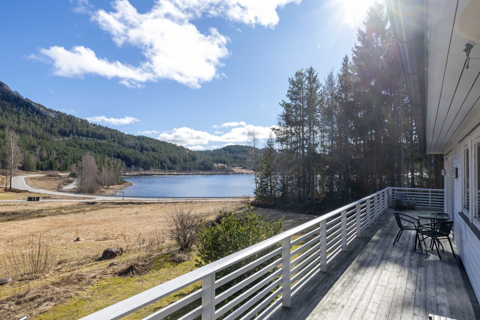 Langstrakt veranda med direkte adkomst fra boligen og utsikt mot vannet. Galleribilde