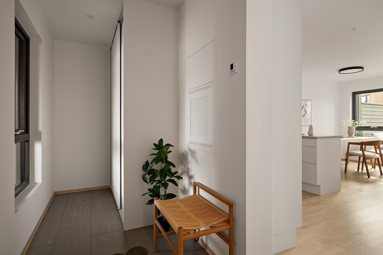 Flislagt entré med skyvedørsgarderobe. Galleribilde