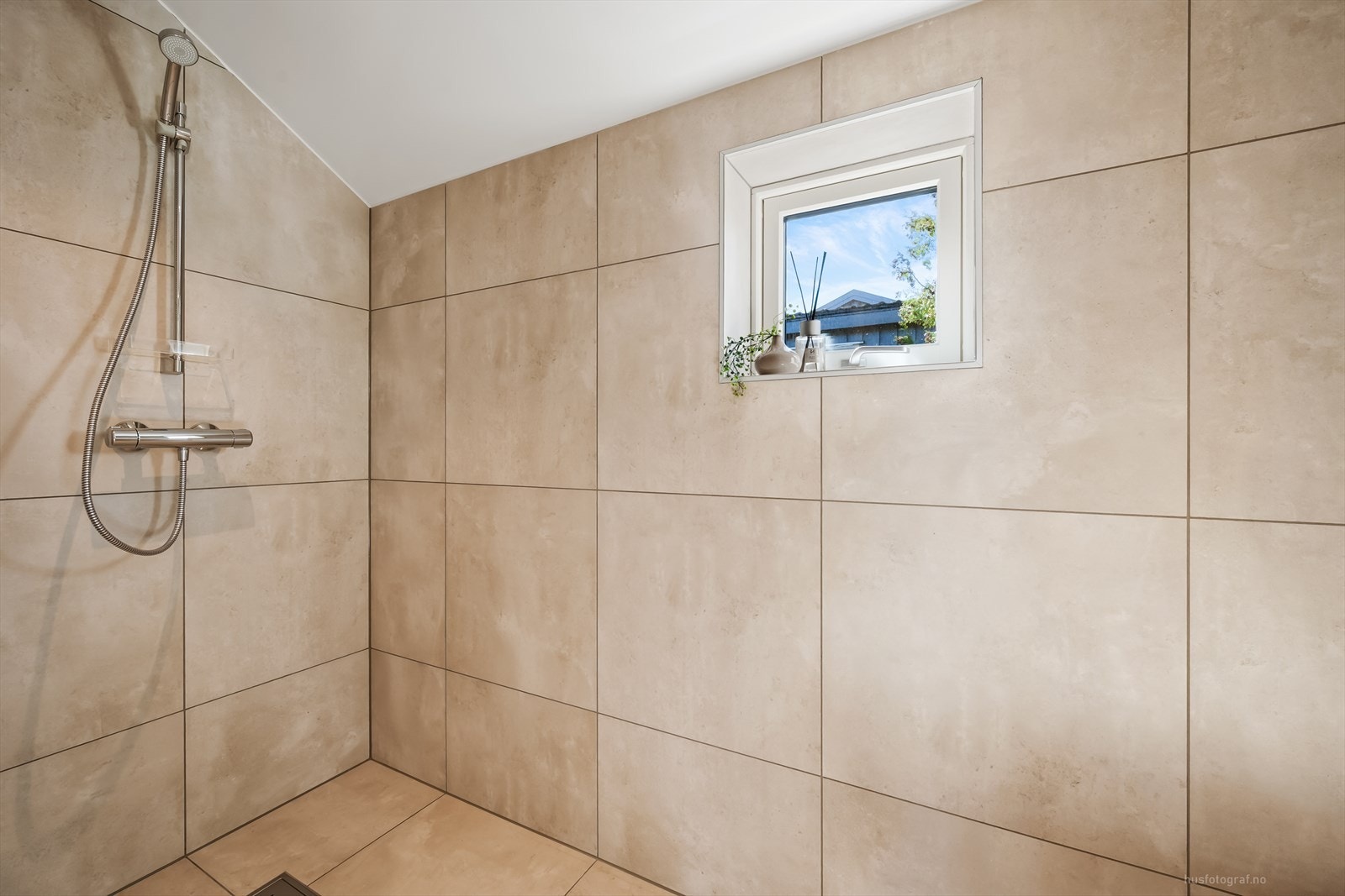 Badet i 2. etasje er utstyrt med vegghengt toalett, hvit baderomsinnredning med speilskap og dusjnisje. Galleribilde