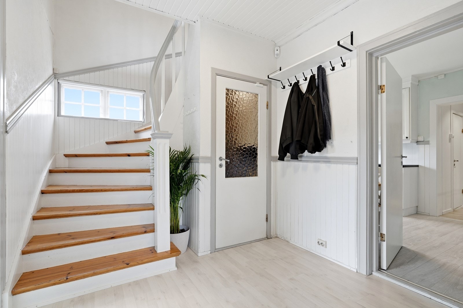 Entréen og gangen i første etasje binder rommene sammen. Den lakkerte og malte tretrappen leder opp til andre etasje. Galleribilde