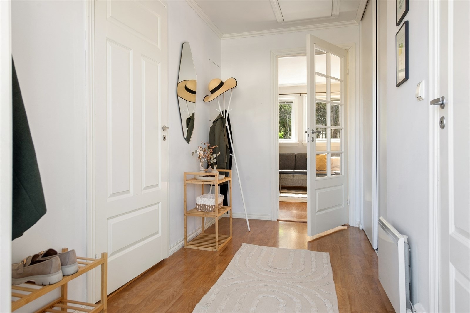 Fra gangen leder en dør med glassfelt inn til stuen, noe som bidrar til en åpen og lys romfølelse. Galleribilde