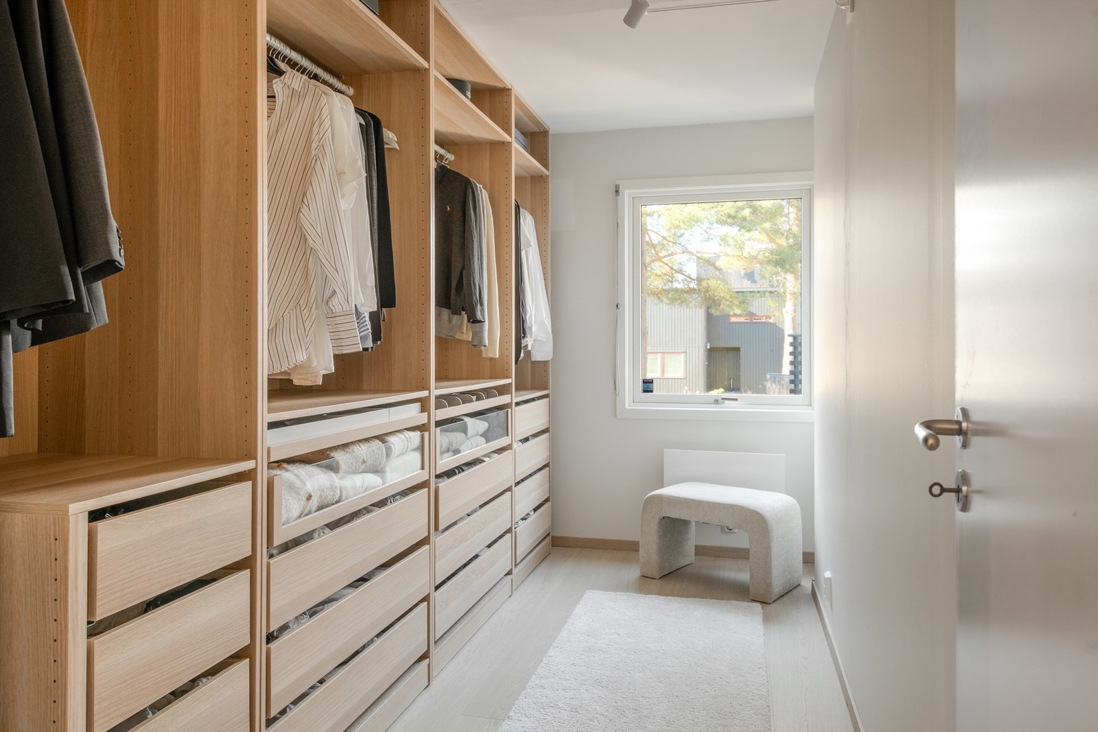 Et av rommene er innredet som en romslig walk-in-garderobe med skreddersydd innredning. Galleribilde