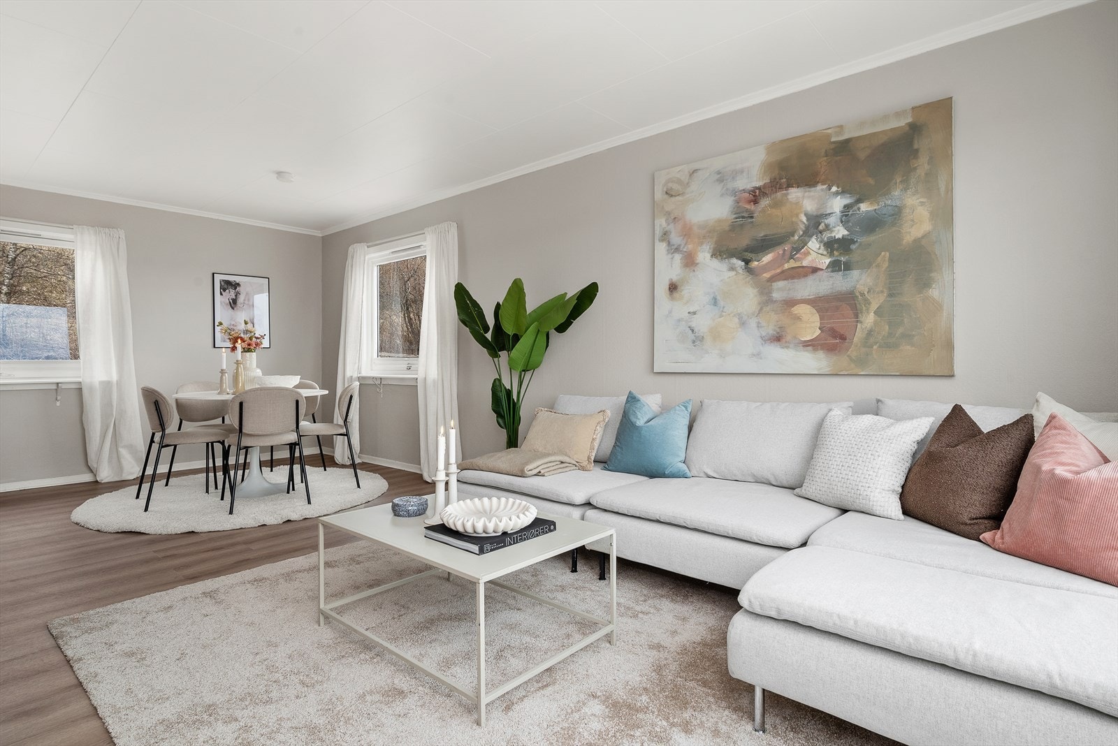 Vinduer på tre sider slipper inn godt med naturlig lys til stuen. Galleribilde