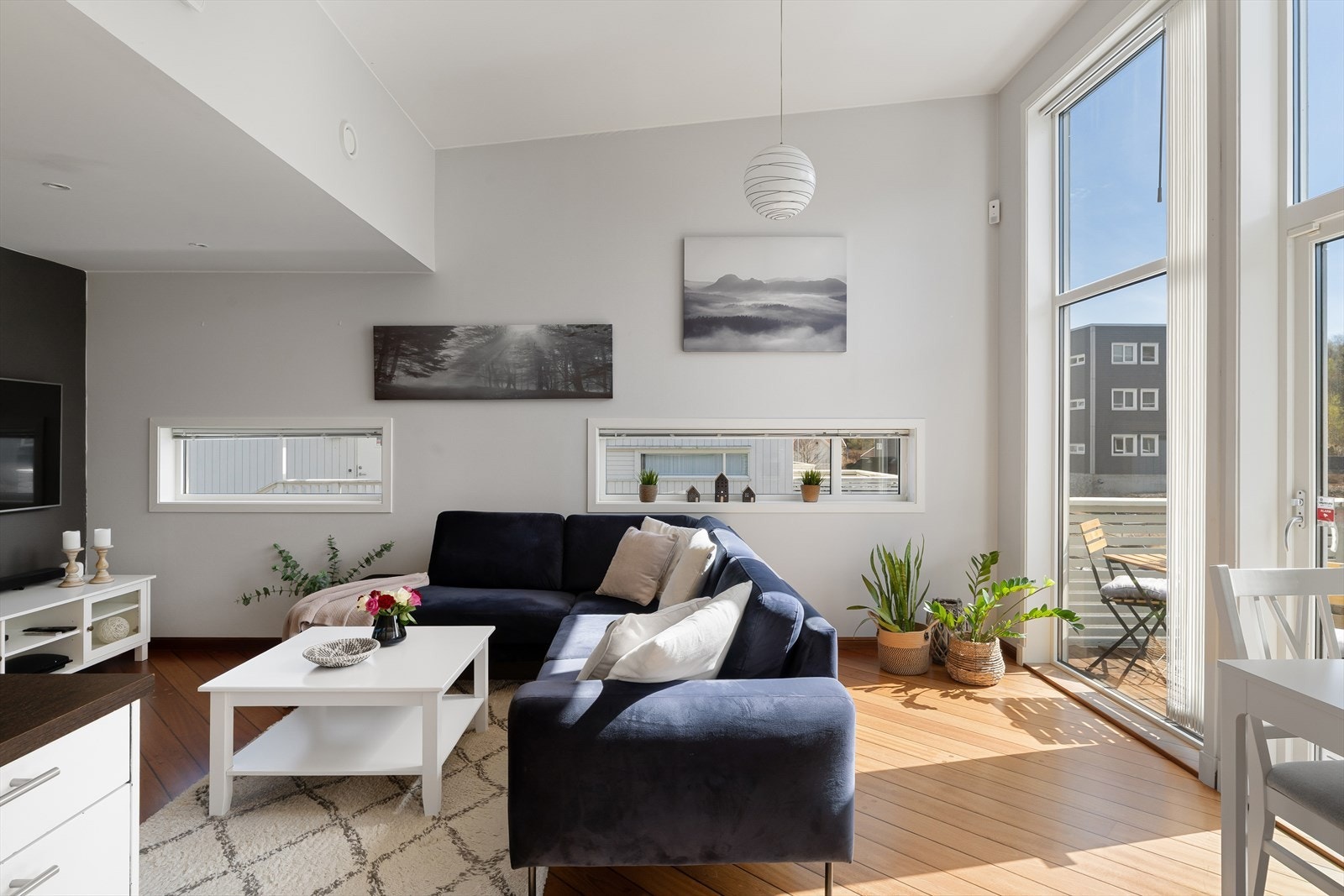 Leilighetens stue fremstår som lys og trivelig med store vindusflater som slipper inn mye naturlig lys, som sammen med den ekstra takhøyden er med på å skape en god romfølelse og atmosfære i rommet. Galleribilde