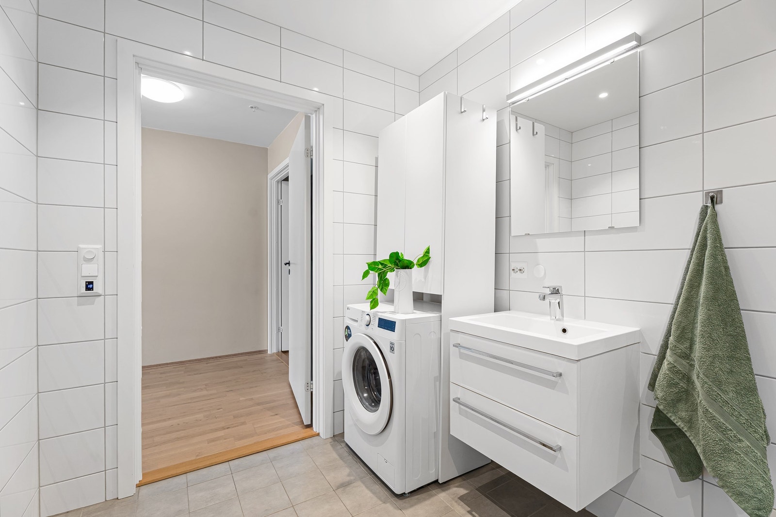 Det er downlights i himlingen og nisje med opplegg til vaskemaskin og eventuelt tørketrommel. Det er i dag satt inn en nisje med ekstra oppbevaringsskap. Galleribilde