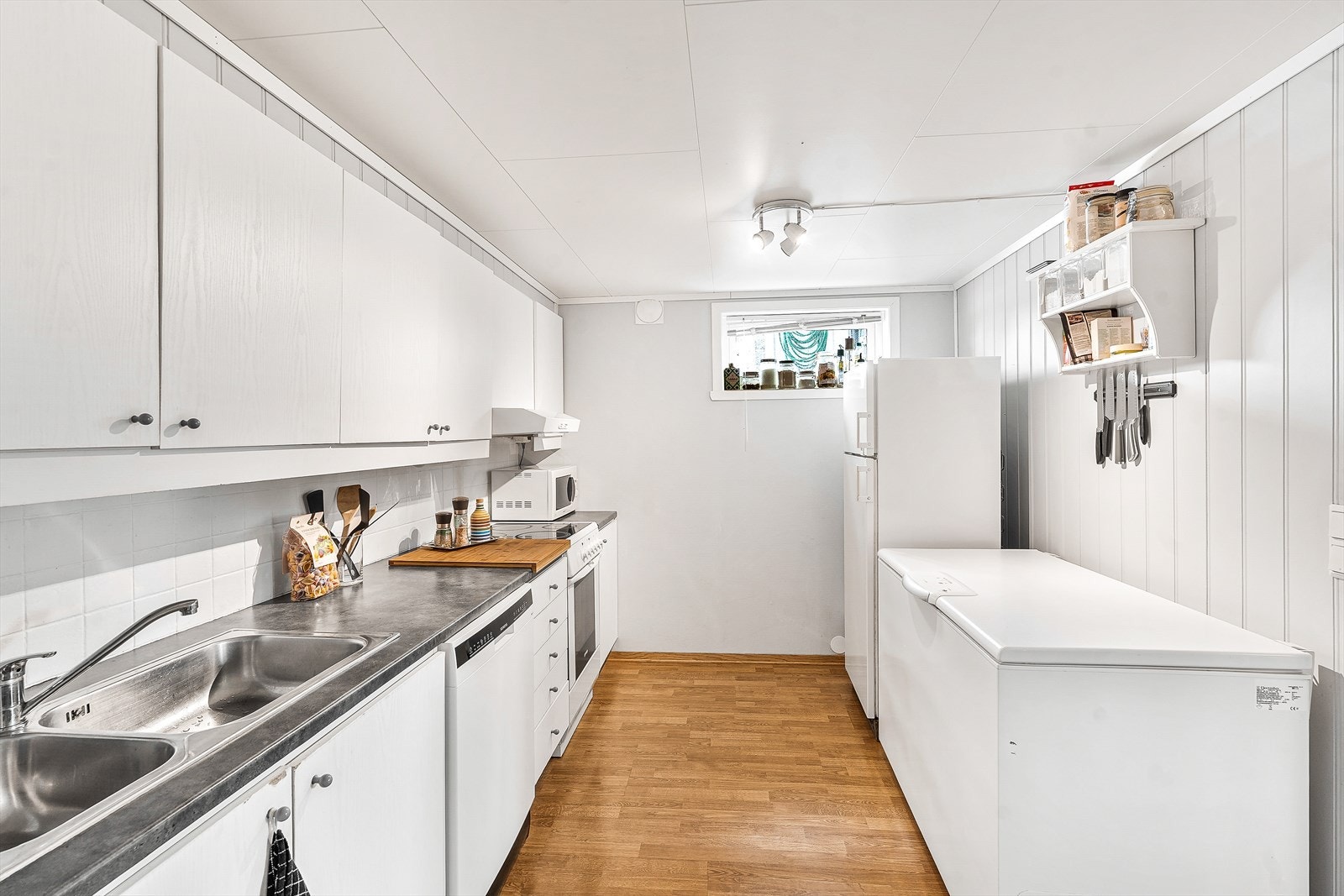 Kjøkkenet har slette fronter og benkeplate av laminat Galleribilde