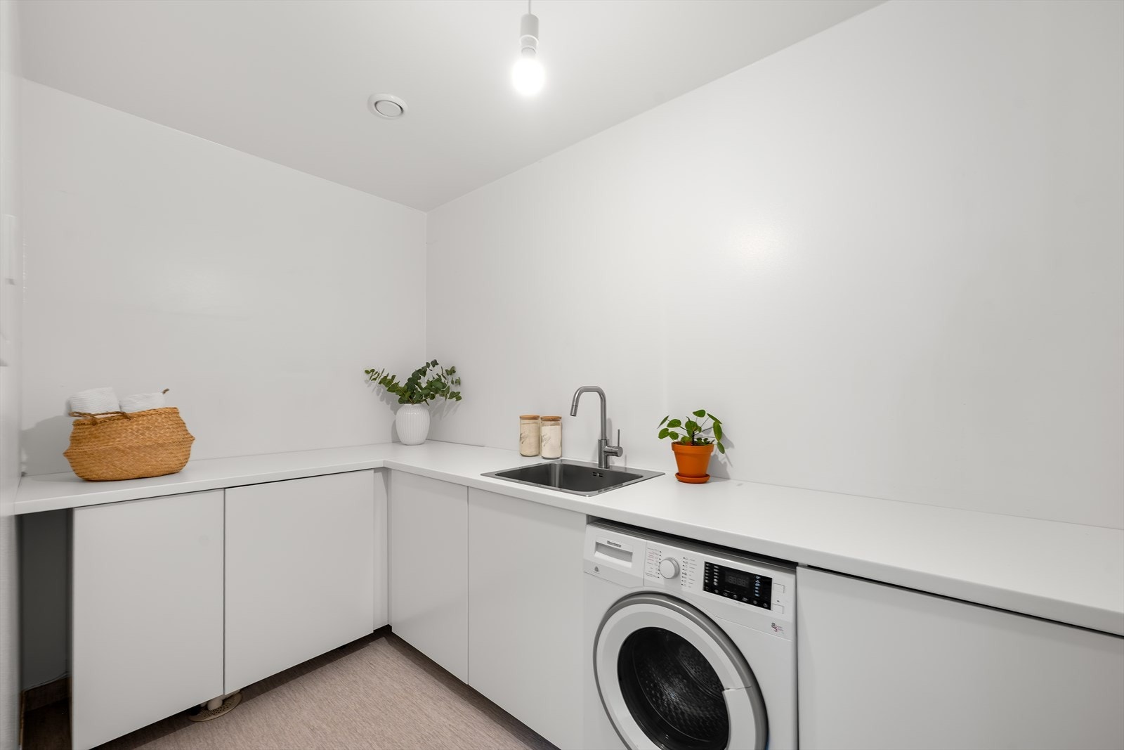 Separat og praktisk vaskerom. Rommet har belegg på gulv med vannbåren varme, god benkeplass og opplegg for vaskemaskin. Galleribilde