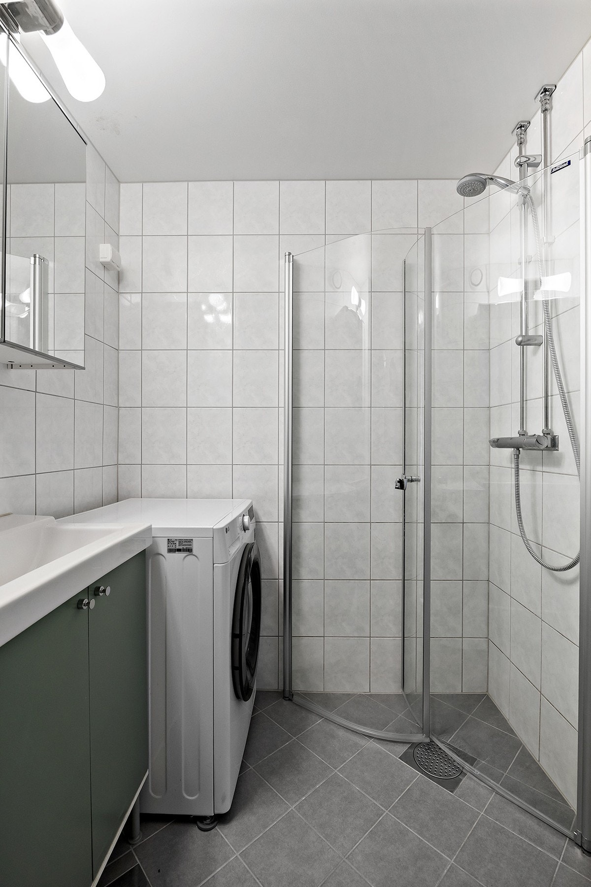 Bad/wc består av inn- utadslående dusjvegger, servant m/underskap, overskap m/speilfronter og overlys, skap, veggklosett og opplegg for vaskemaskin. Galleribilde