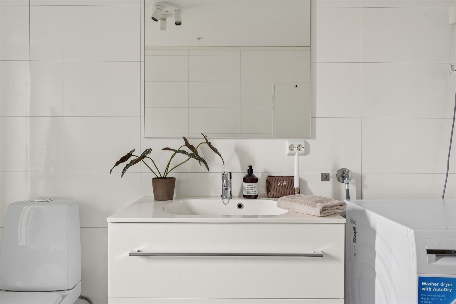 Badet er ellers utstyrt med dusjhjørne, toalett og baderomsinnredning med nedfelt servant. I tillegg har man opplegg for vaskemaskin. Galleribilde