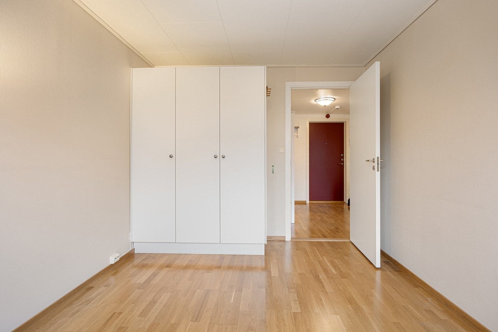 Mot en av veggene er plassert et hvitt, tredørs garderobeskap med gode oppbevaringsmuligheter. Lagringsplass finnes i disponibel bod i tilknytning til garasjeplassen. Galleribilde