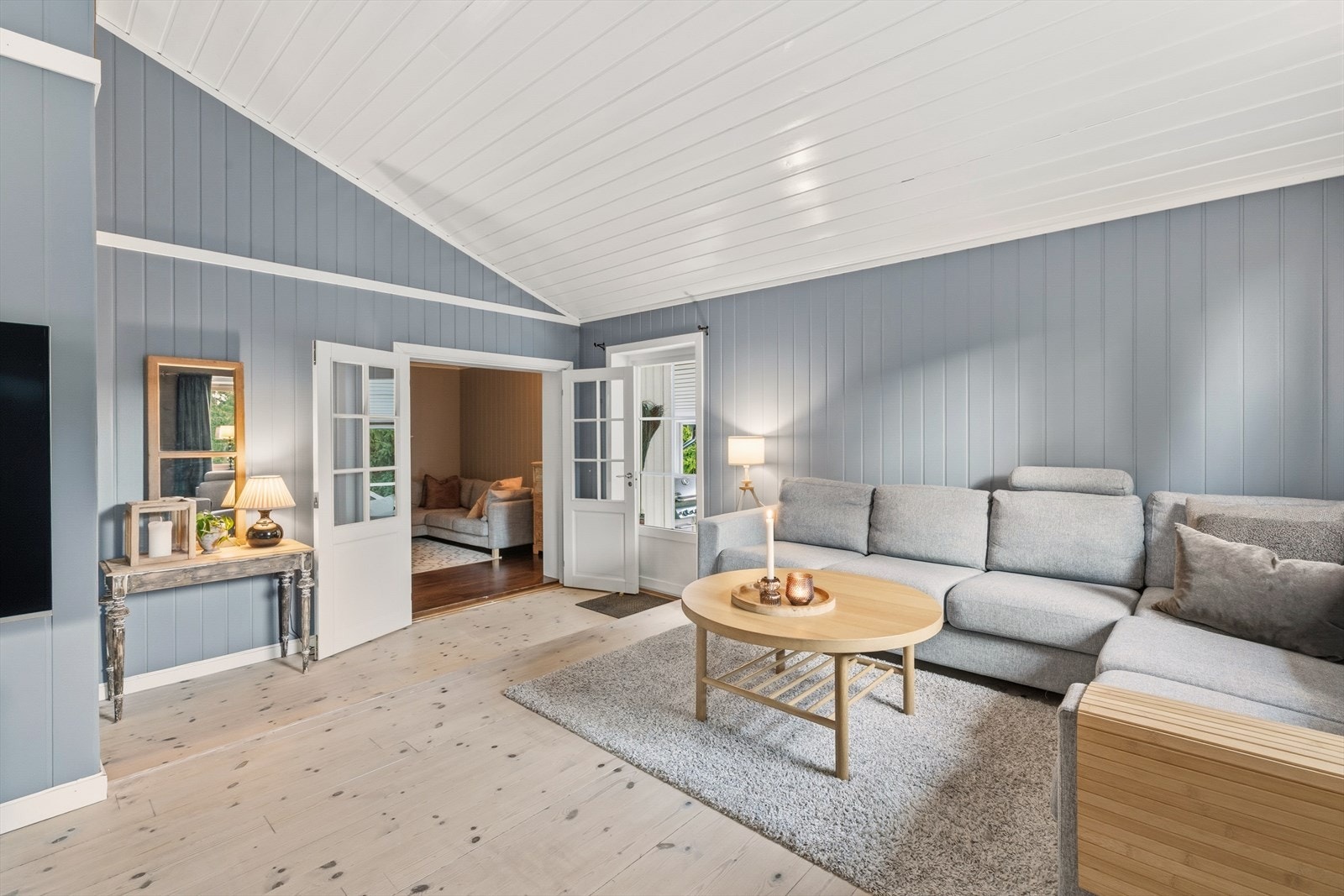 Stuen har et romslig areal, malt i moderne fargetoner og parkettgulv. Galleribilde