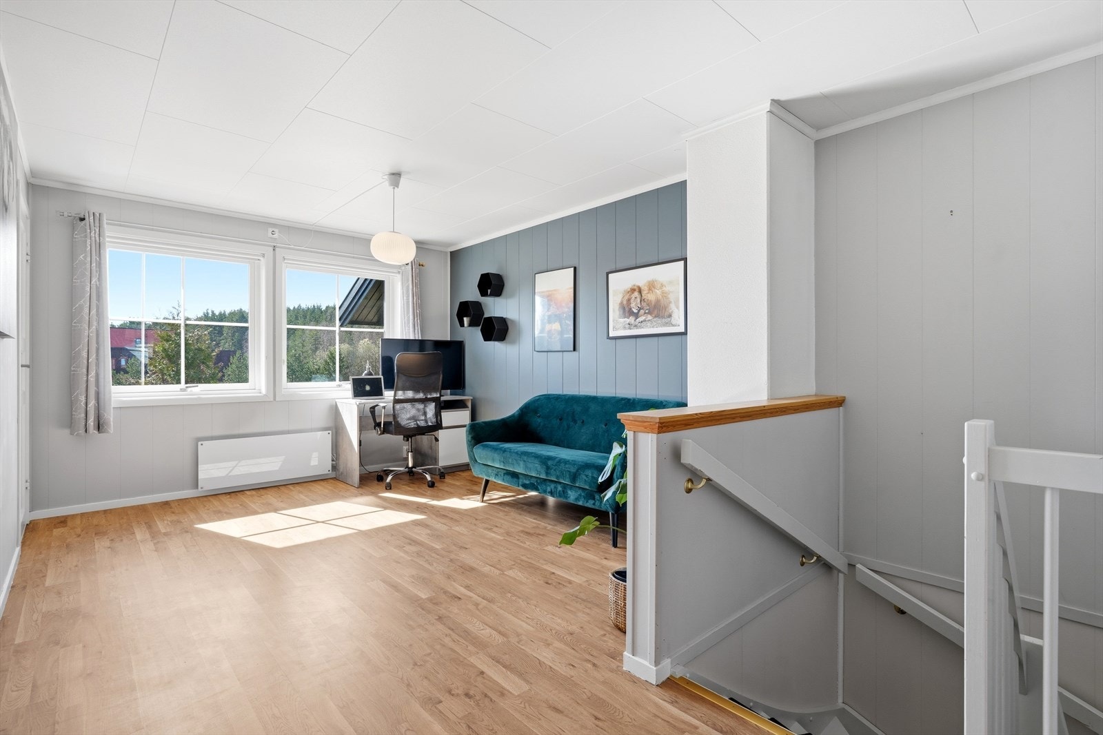 Andre etasje byr på en praktisk loftstue, i dag innredet med sofa og kontorpult. Galleribilde