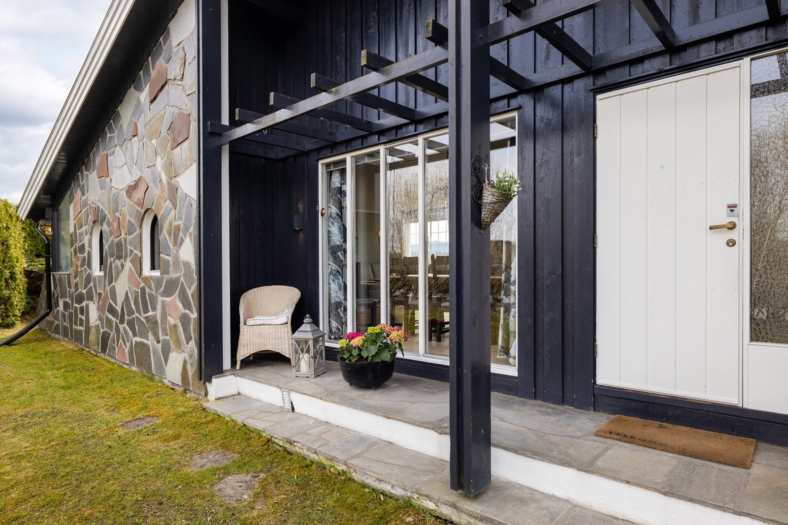 Det overbygde inngangspartiet har skiferheller og en karakteristisk yttervegg i tre og stein. Galleribilde