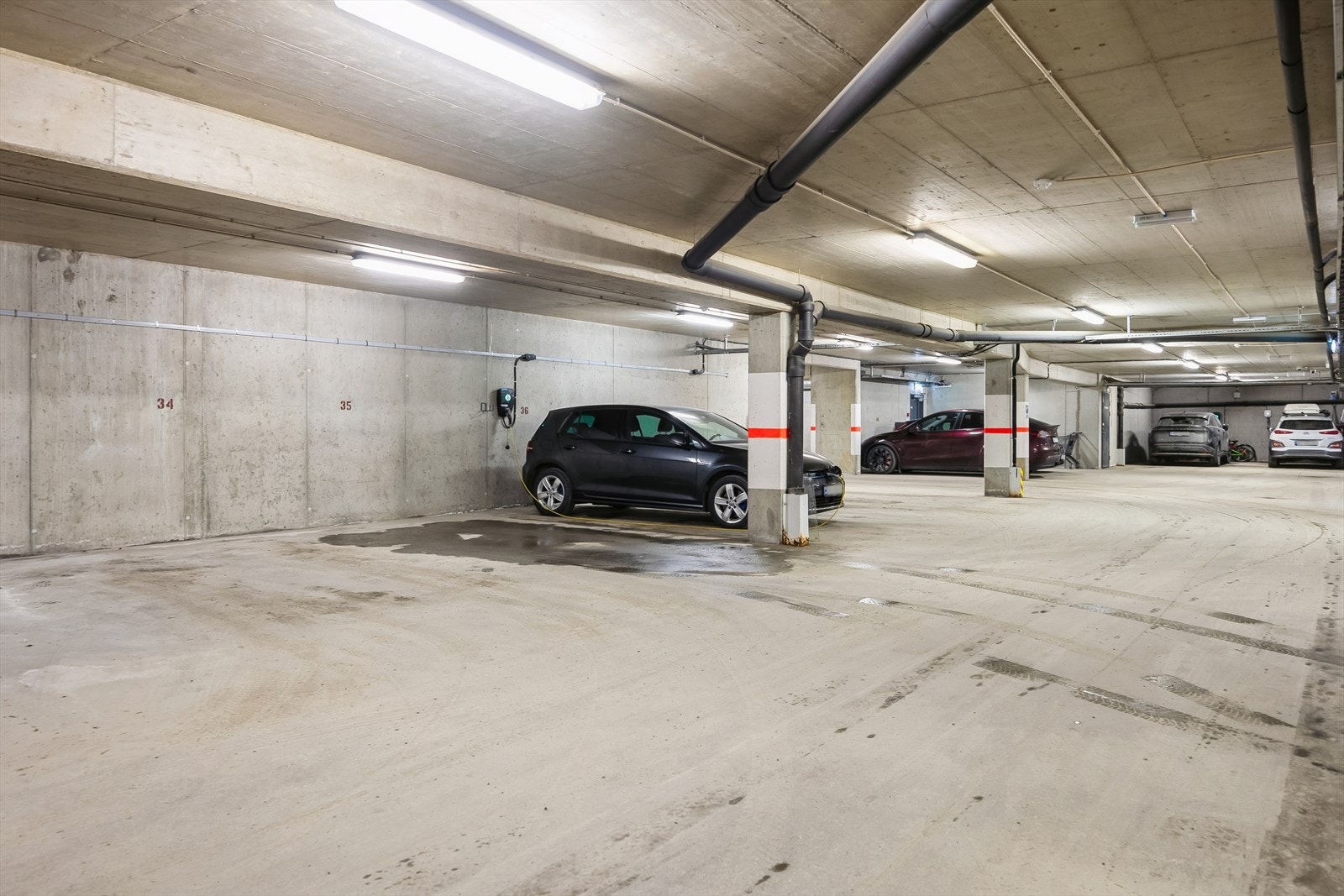 Leiligheten disponerer en egen p-plass i kjeller, med opplegg for elbillading. I tillegg er det mange gjesteparkeringer tilknyttet garasjeanlegget. Galleribilde