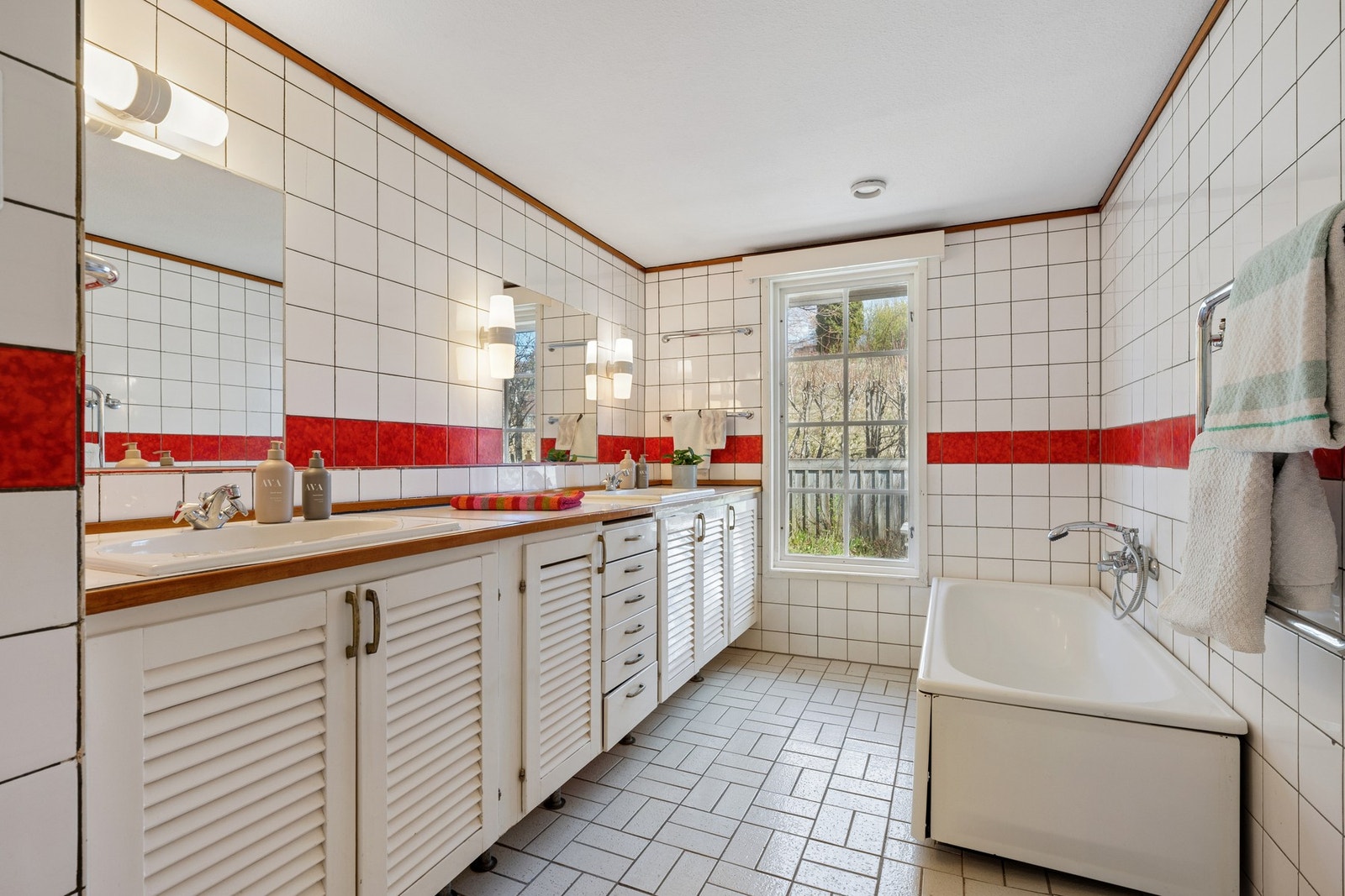 Baderommet er utstyrt med badekar og stor innredning med dobbel servant løsning. Galleribilde