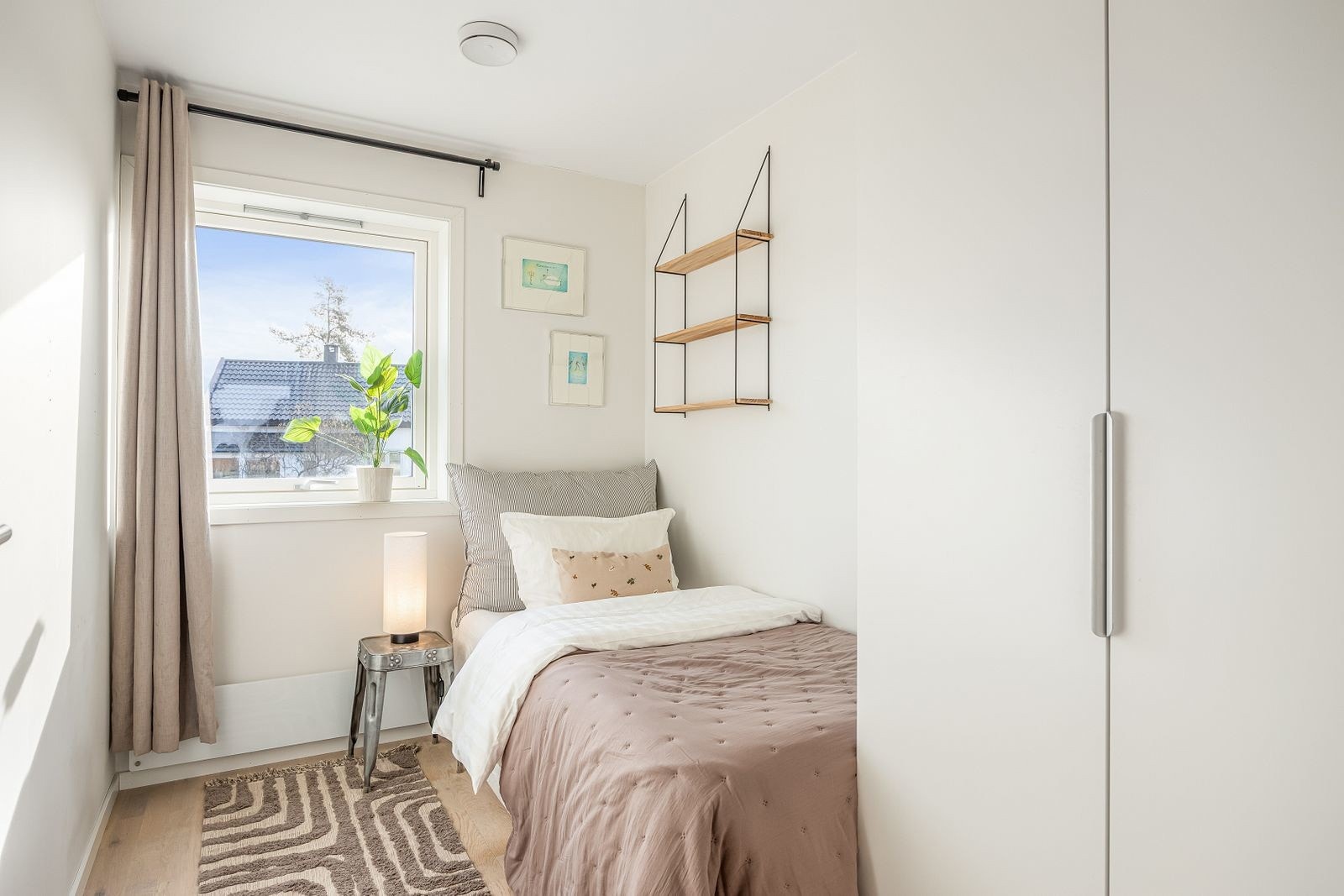 Lyst og koselig soverom med god garderobeløsning, store skap langs veggen og vindu som slipper inn naturlig lys - passer perfekt som barnerom eller gjesterom. Galleribilde