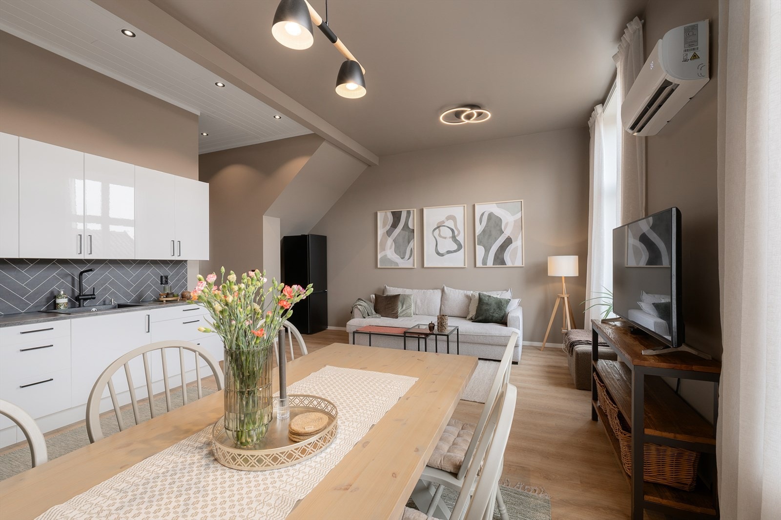 Den åpne løsningen gir fleksibilitet for møblering av både sofagruppe og spiseplass. Galleribilde