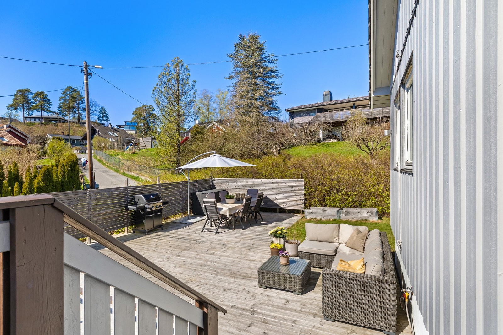 Sørvendt terrasse og en sør/nord/østvendt platting på rundt 59 m² med adkomst fra spisestue/stue og hage Galleribilde