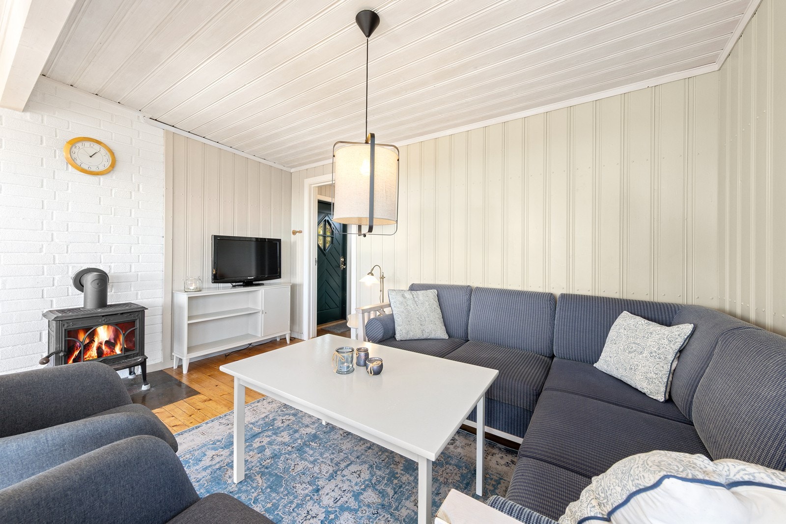Vedovnen i stuen sørger for varme og hygge. Store deler av det elektriske anlegget i hytta ble skiftet ut i 2024. Galleribilde