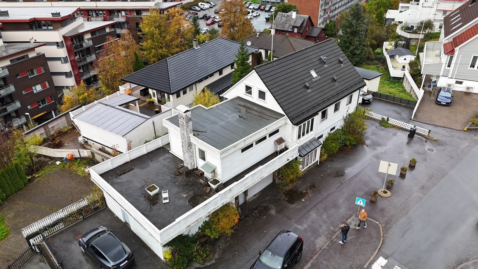 Eiendommen sett fra luften, med den store terrassen og parkeringsarealet godt synlig. Galleribilde