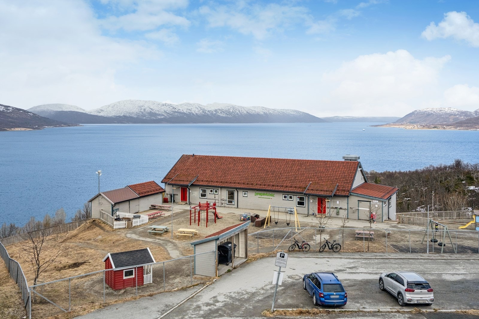 Utsikt fra inngangspart over nærliggende barnehage og sundet mellom Kvaløya og fastlandet i retning Ringvassøy Galleribilde