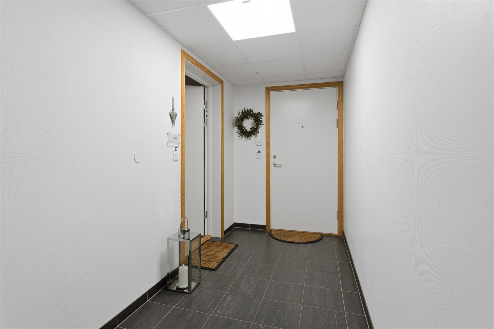 Etter å ha kommet seg opp til byggets 3. etasje via heis eller trapp, valget er ditt, er det kort vei til den innvendige gangen til leilighetens inngangsdør. Galleribilde