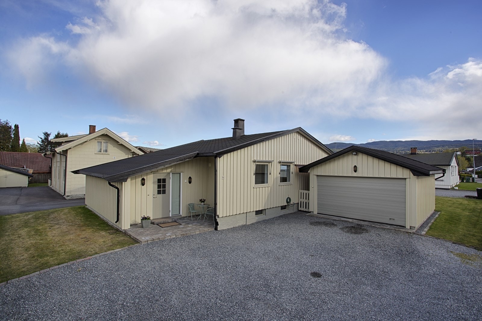 Eiendommen har en romslig, gruset gårdsplass og en garasje på 29 m² oppført i 2006, med automatisk portåpner. Galleribilde