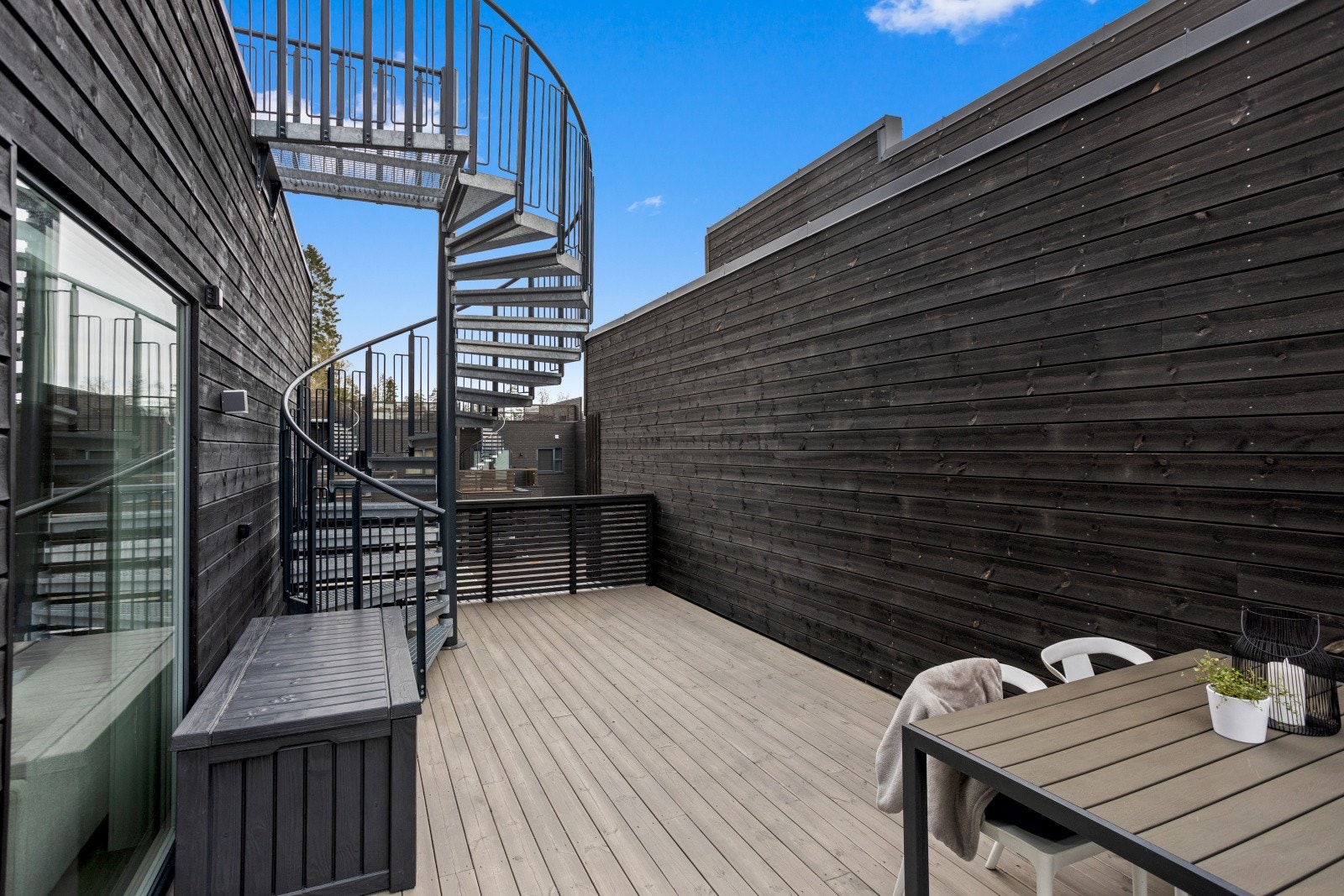Herfra leder en stilren spiraltrapp i stål videre opp til boligens herlige og romslige takterrasse, som byr på en privat og attraktiv uteplass med flotte solforhold og god plass til både avslapning og sosiale sammenkomster. Galleribilde