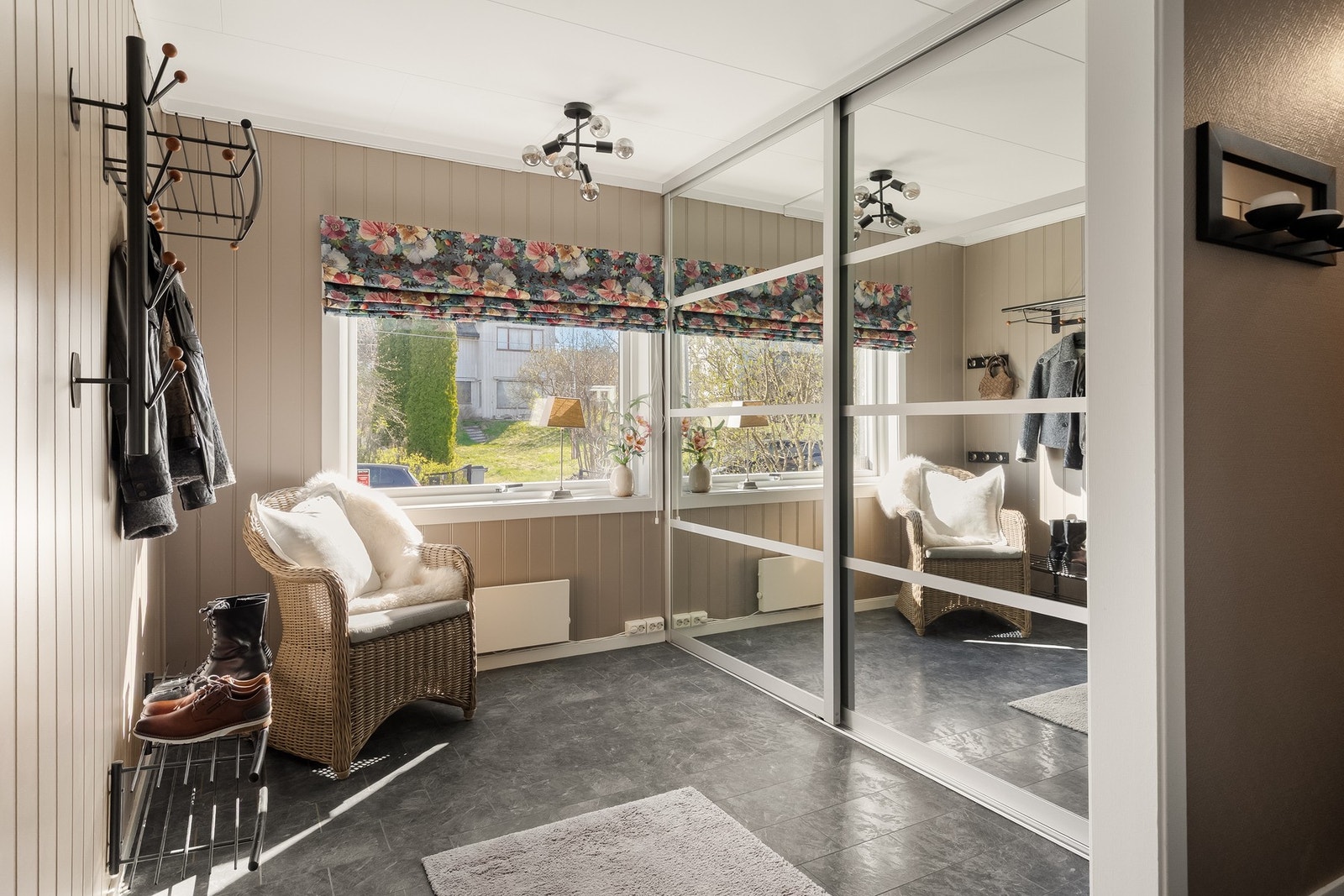 Stor og praktisk entré/gang med garderobeskap av speilfronter og oppheng på vegg. Galleribilde