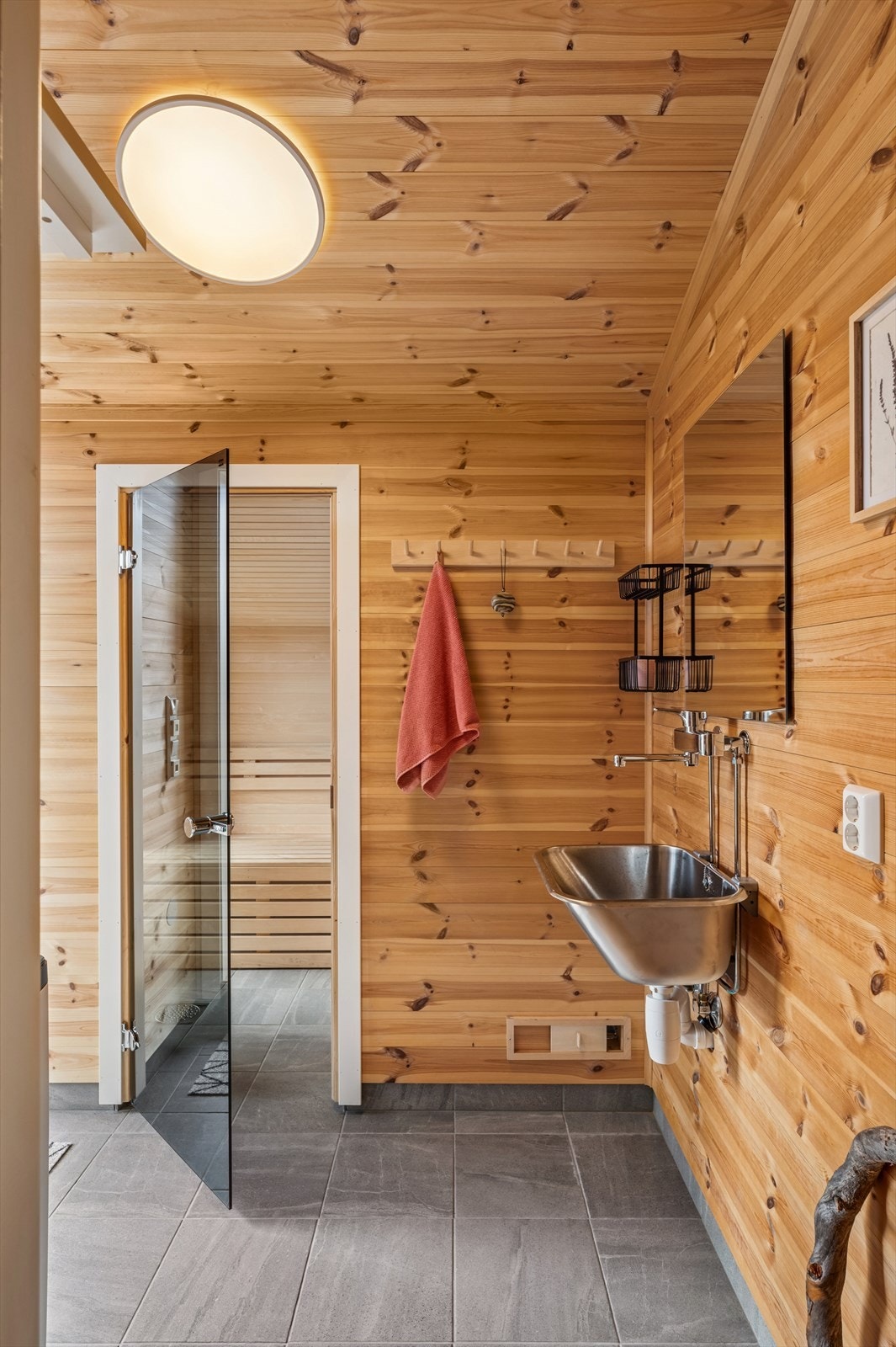 I gang nr 2, finner du en praktisk utslagsvask - perfekt etter turer i skog og mark. Herfra har du også tilgang til boligens badstue, som byr på velvære og avslapning etter en aktiv dag. Galleribilde