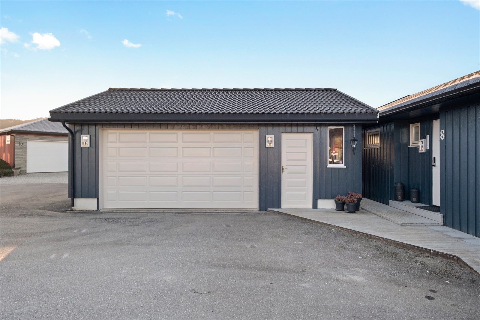 Garasje med hvite porter gir et stilrent uttrykk. Galleribilde