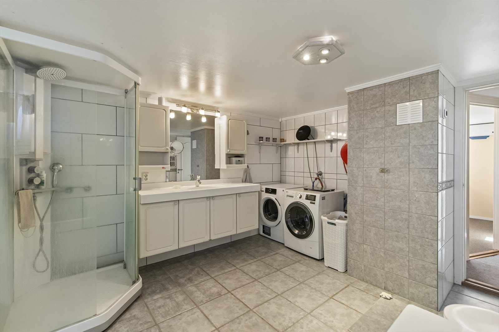 Badet er utstyrt med dusjkabinett, badekar, servant og toalett, samt opplegg for vaskemaskin og tørketrommel. Galleribilde
