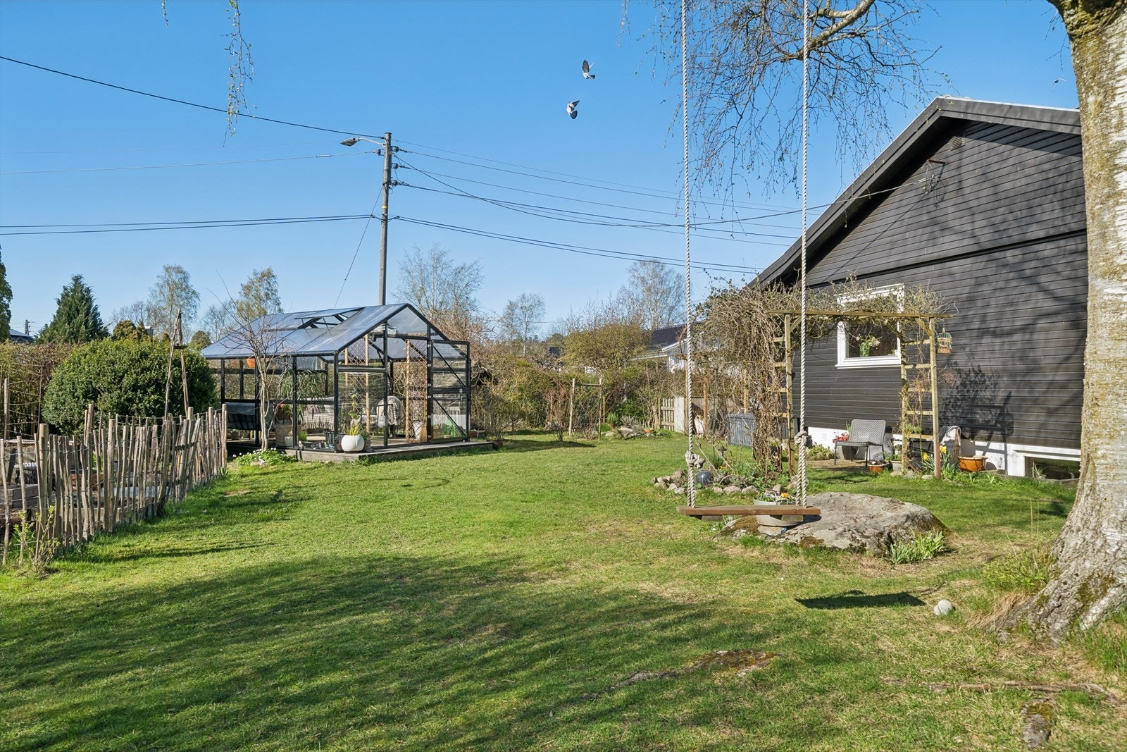 Hagen rommer også et sjarmerende drivhus som er innredet som en hyggelig utestue - et perfekt sted for lange sommerkvelder, kaffepauser eller beskyttet opphold på kjøligere dager Galleribilde