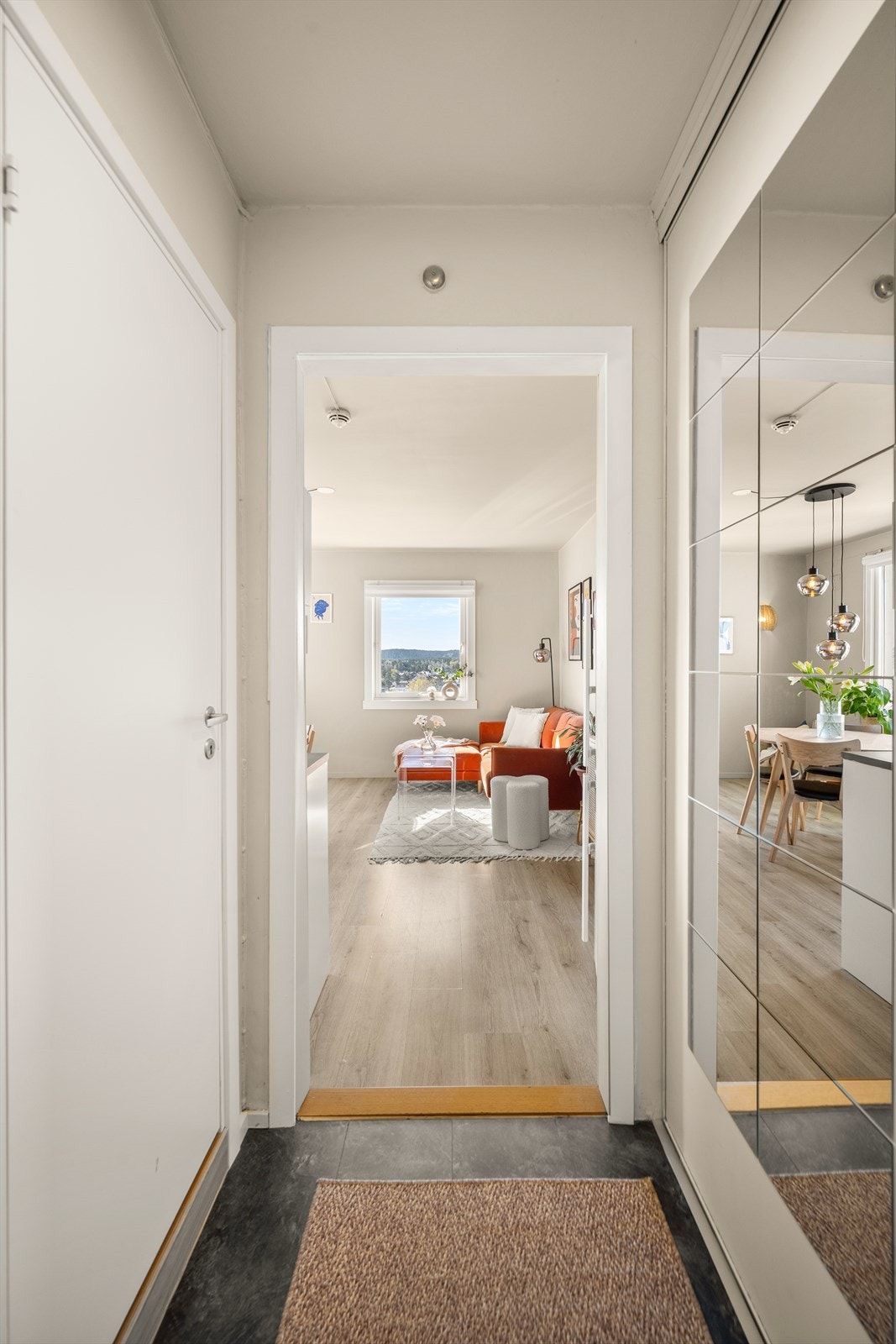 Entréen ønsker deg velkommen inn i leiligheten og leder deg videre inn i den åpne stue- og kjøkkenløsningen. Foto: Martine Eren Jacobsen Galleribilde