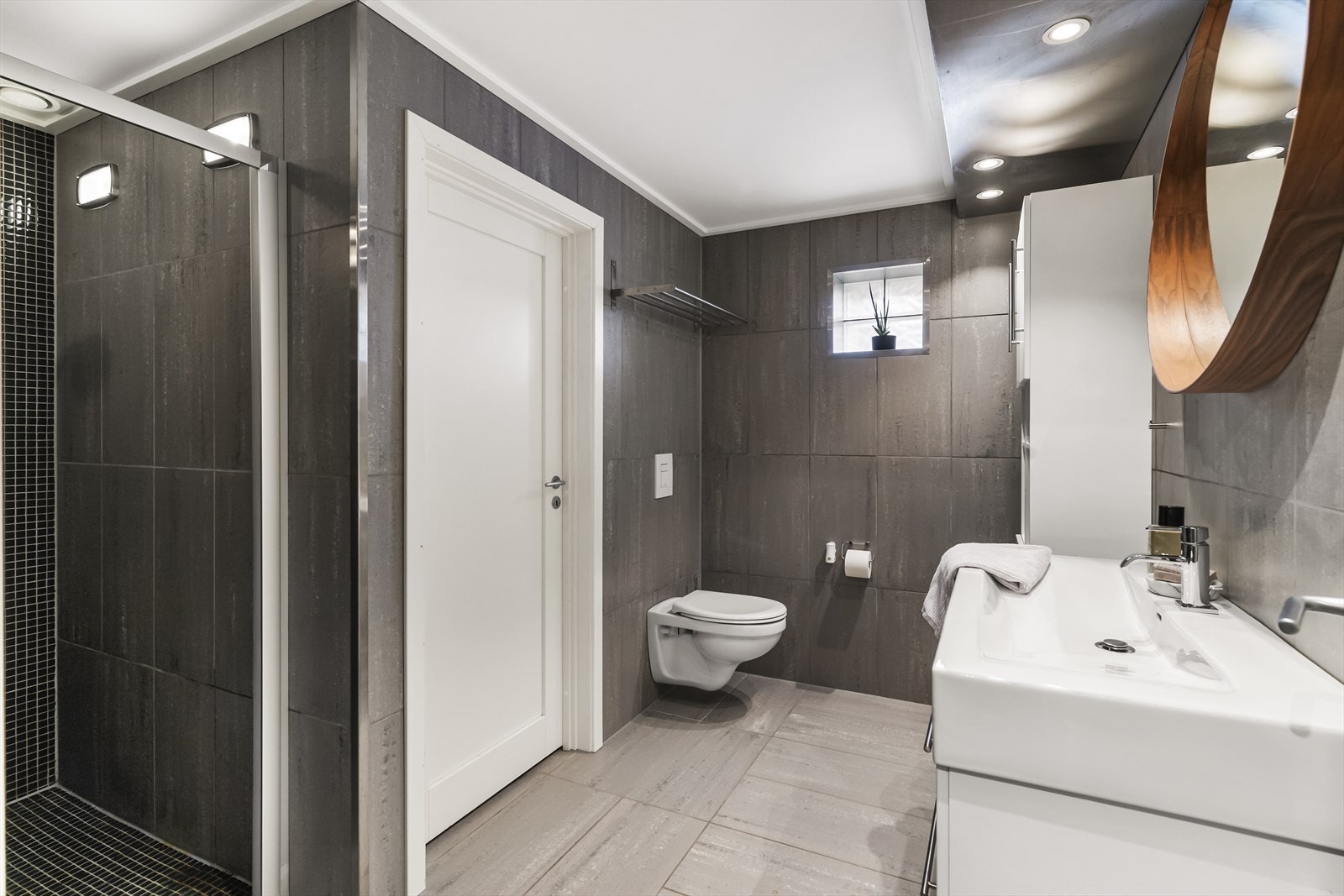 Badet i underetasjen har flislagte overflater, dusjnisje med mosaikkfliser og vannbåren gulvvarme. Galleribilde