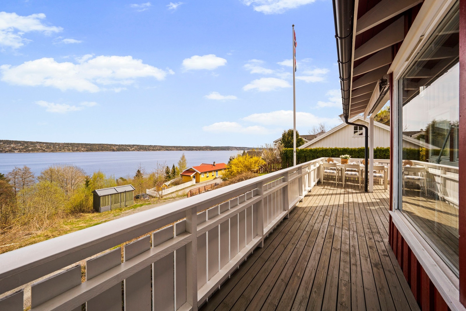 Fra stuen har du utgang til en stor terrasse, som strekker seg rundt hele forsiden av hytta Galleribilde