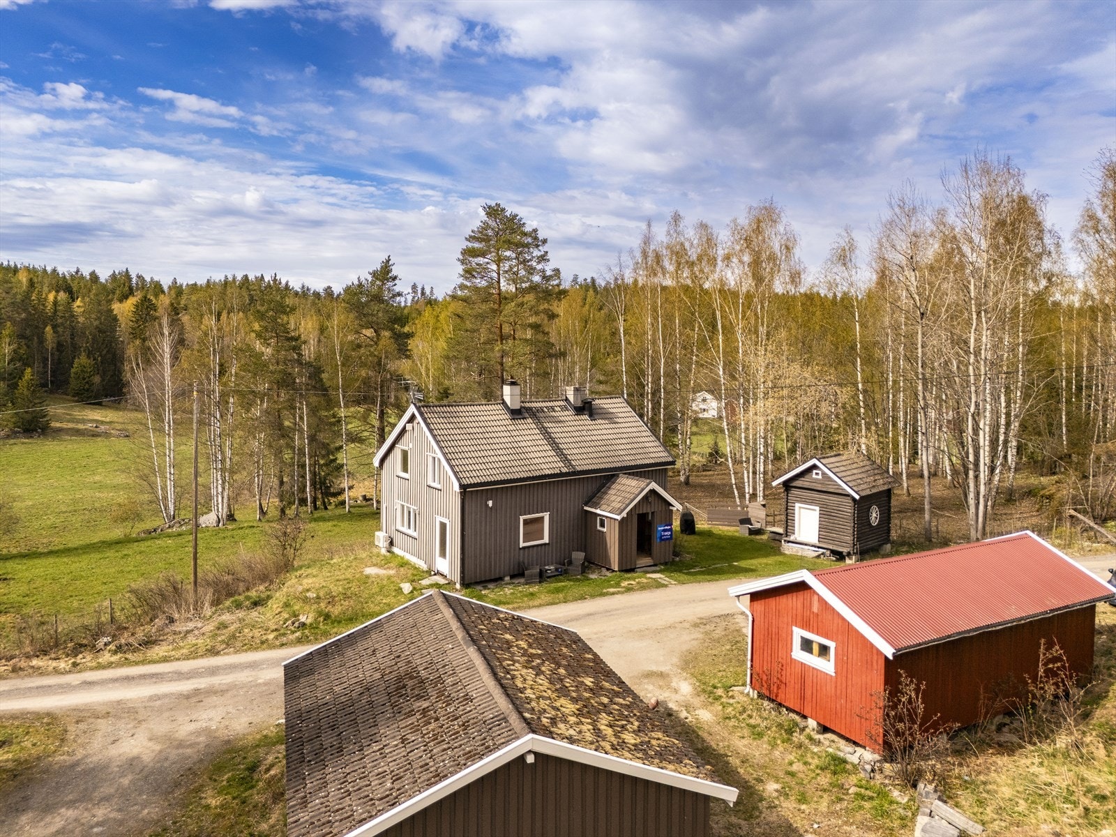 Tomten er på litt over 3 mål med gruset gårdsplass, plen og dels naturtomt. Galleribilde