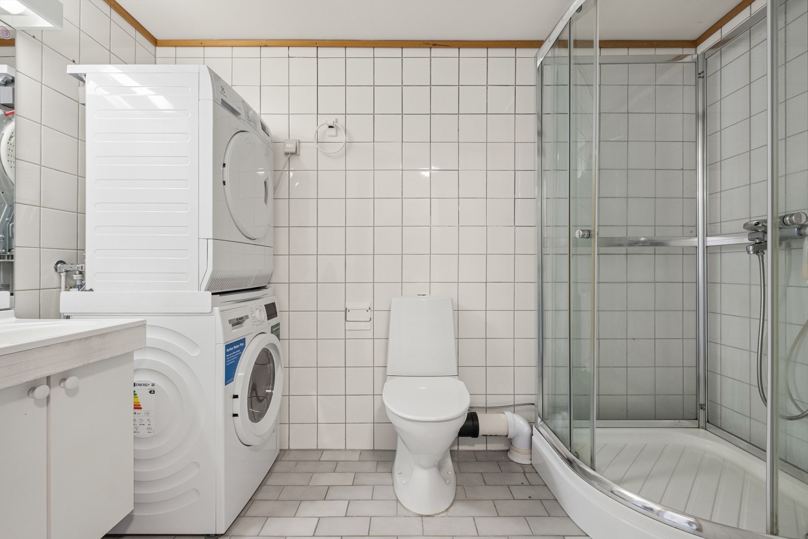 Badet er kombinert vaskerom med opplegg for vaskemaskin og tørketrommel. Galleribilde