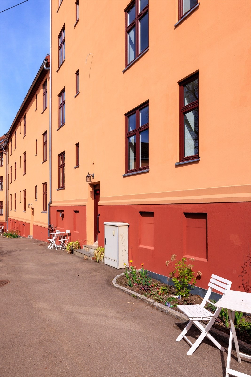 Hyggelig uteplass ved bygget med sittebenk og rolige omgivelser Galleribilde