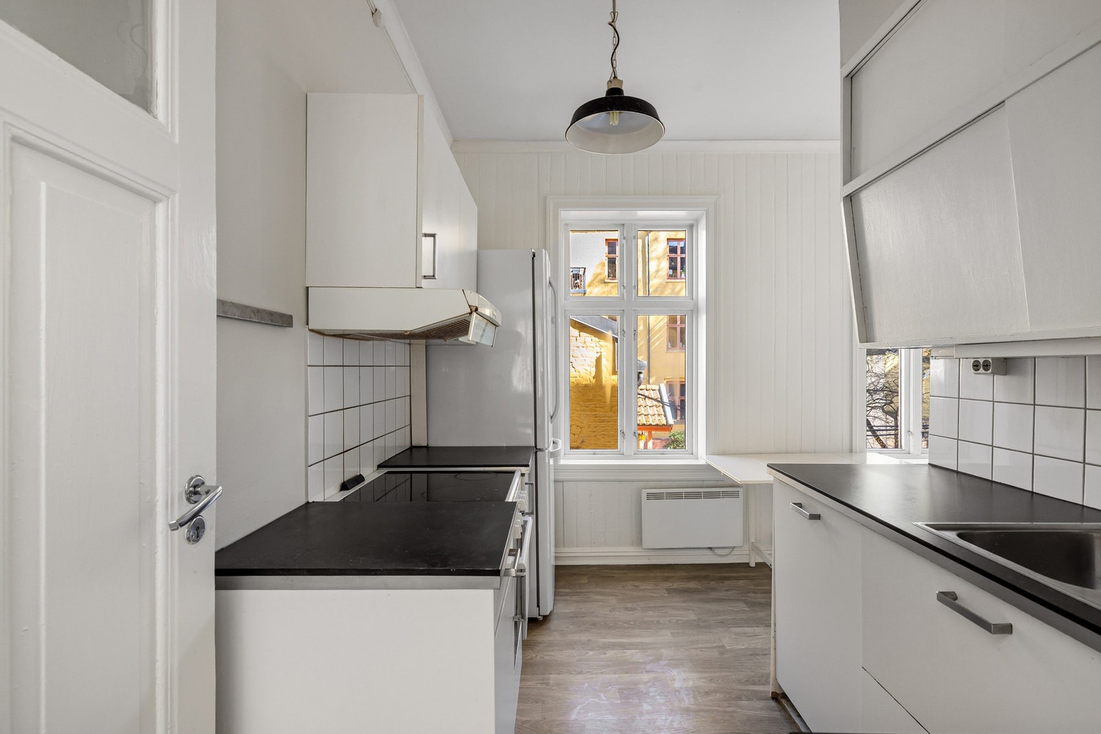 Kjøkken med innredning fra 2014 med glatte fronter og benkeplate med laminert overflate. Galleribilde