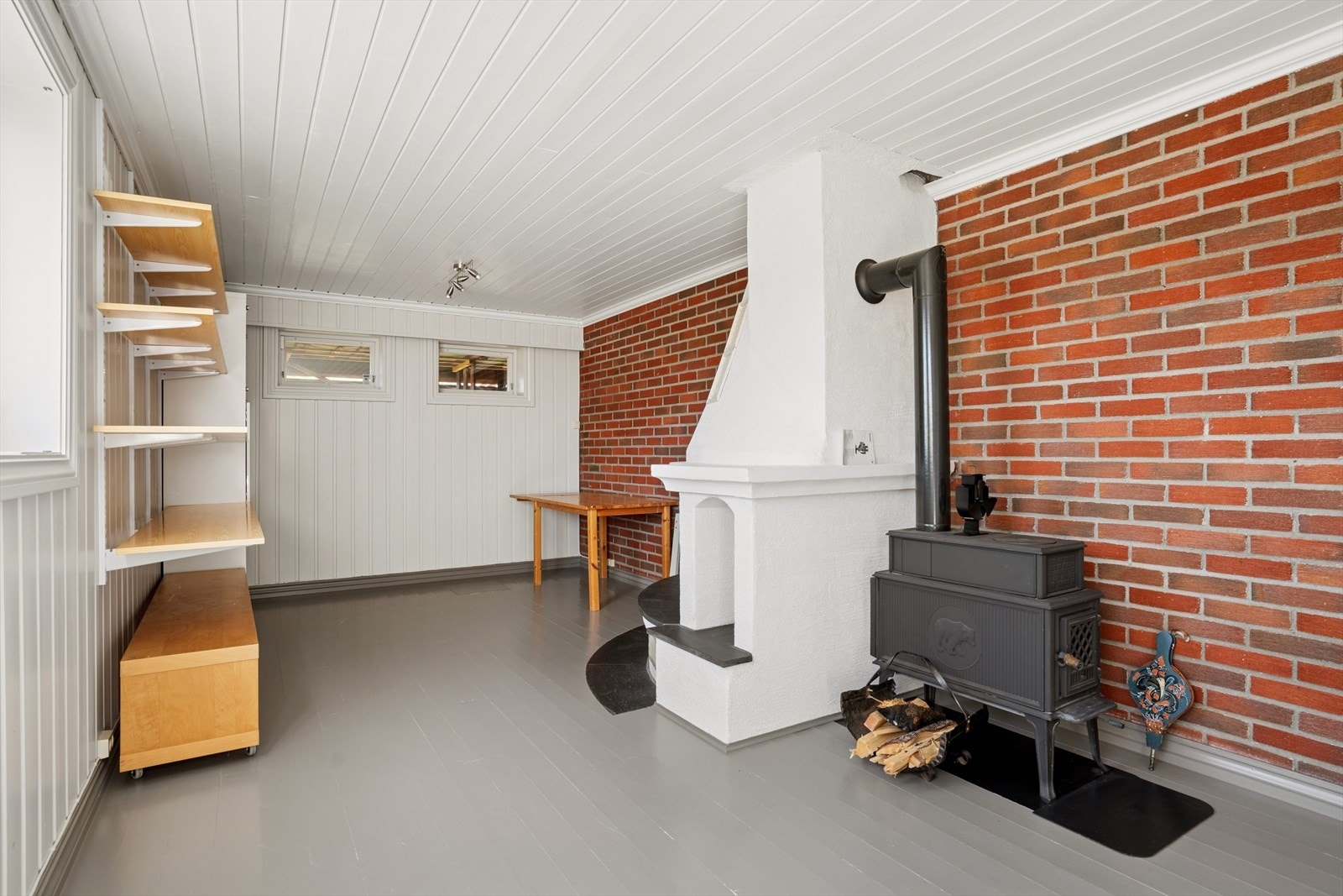 Romslig og stemningsfull kjellerstue med peisovn. Galleribilde