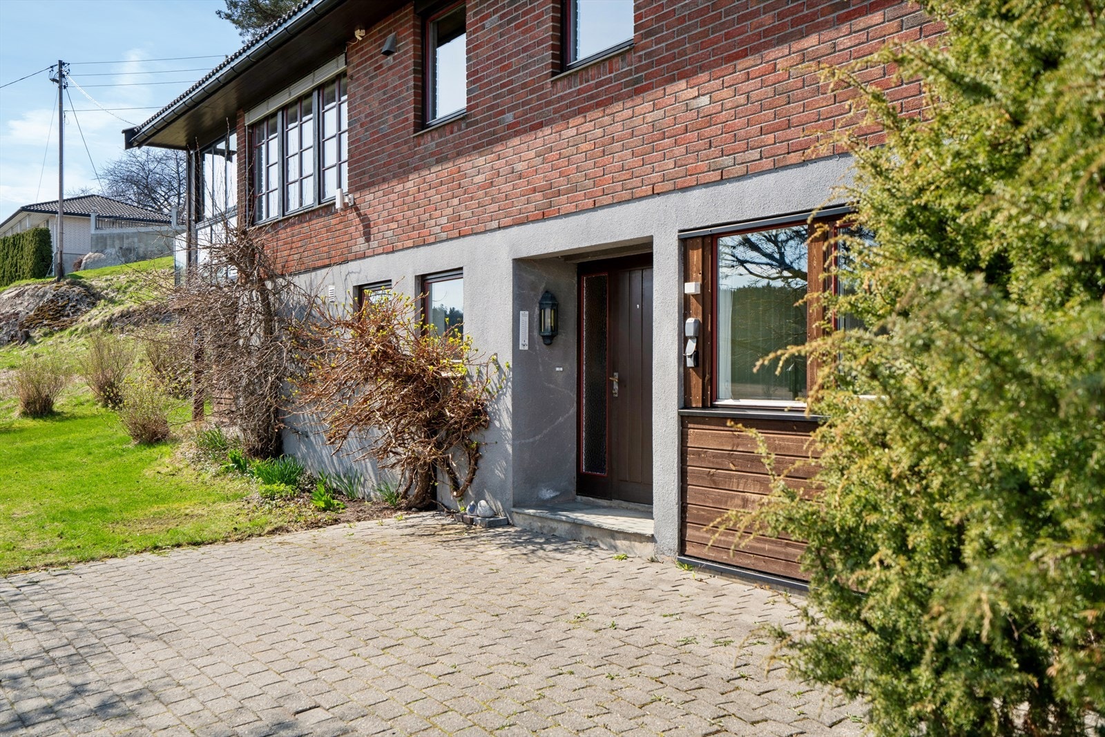 Velkommen inn! Deler av tomten ved inngangspartiet er pent opparbeidet med belegningsstein. Galleribilde
